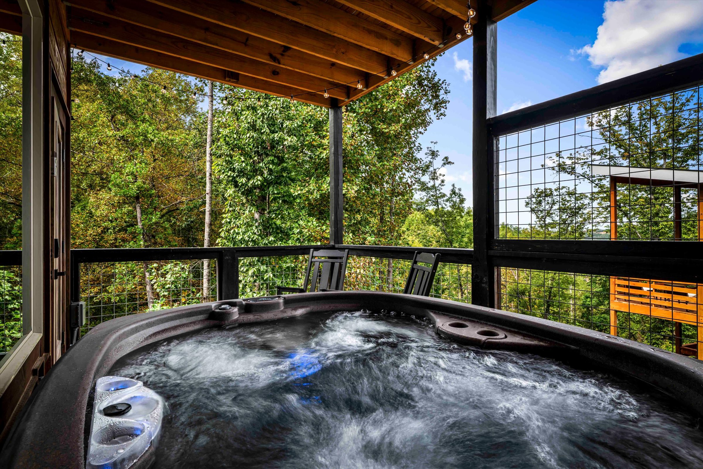 Private covered hot tub deck with peaceful forest views