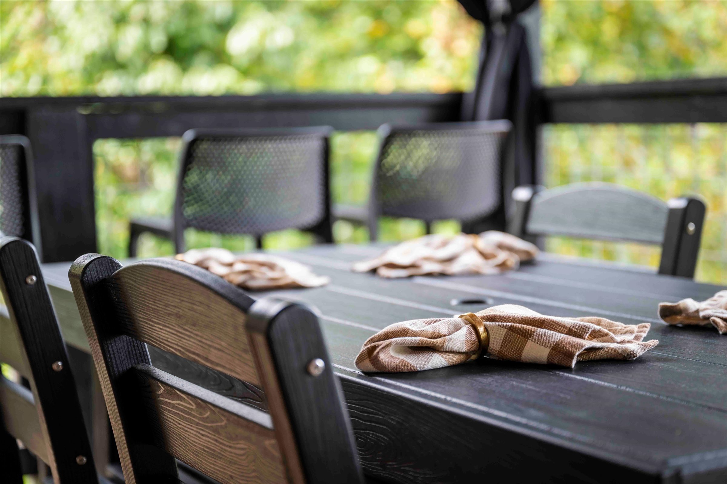 Covered outdoor dining with peaceful wooded views