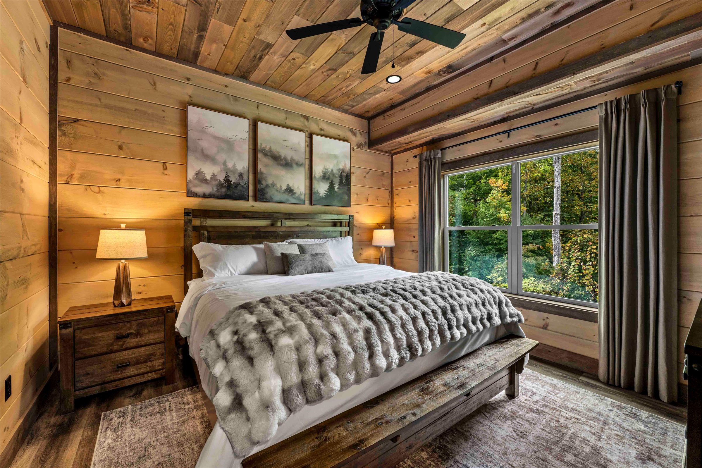Cozy rustic bedroom with forest views and warm wood interiors
