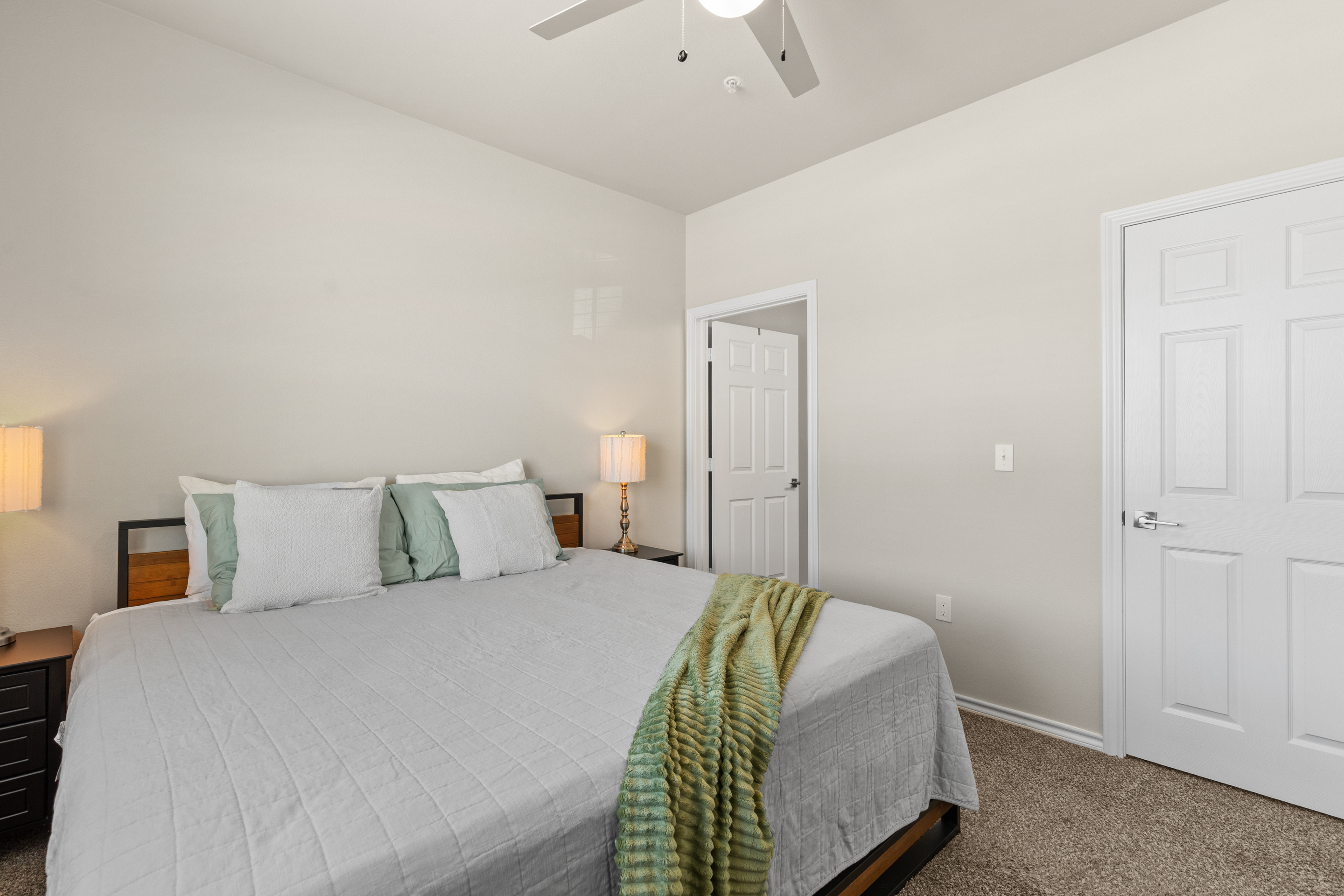 Bright, spacious bedroom with a cozy king bed and calming neutral decor