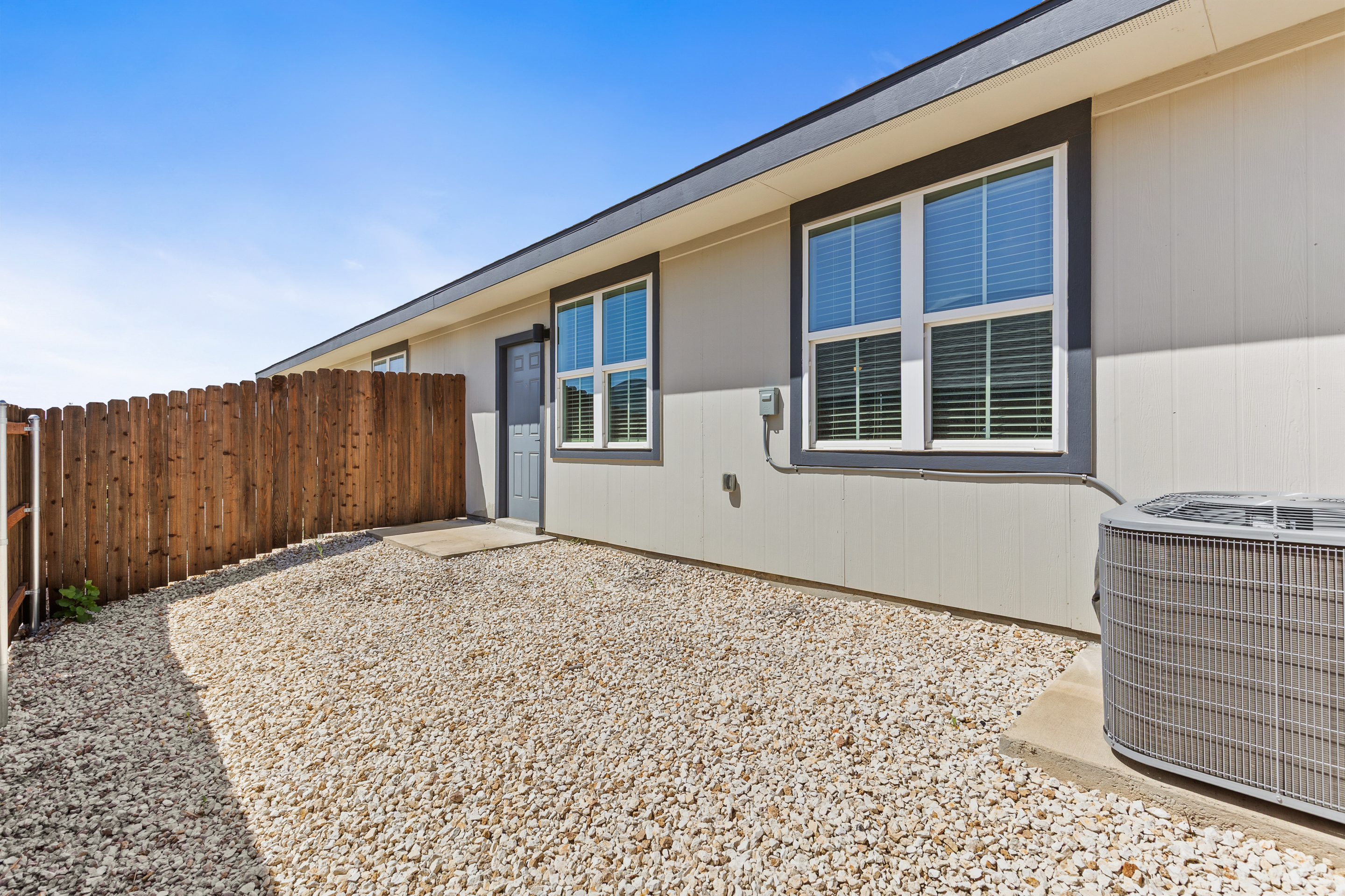 Private fenced side yard with easy entry and low-maintenance outdoor space