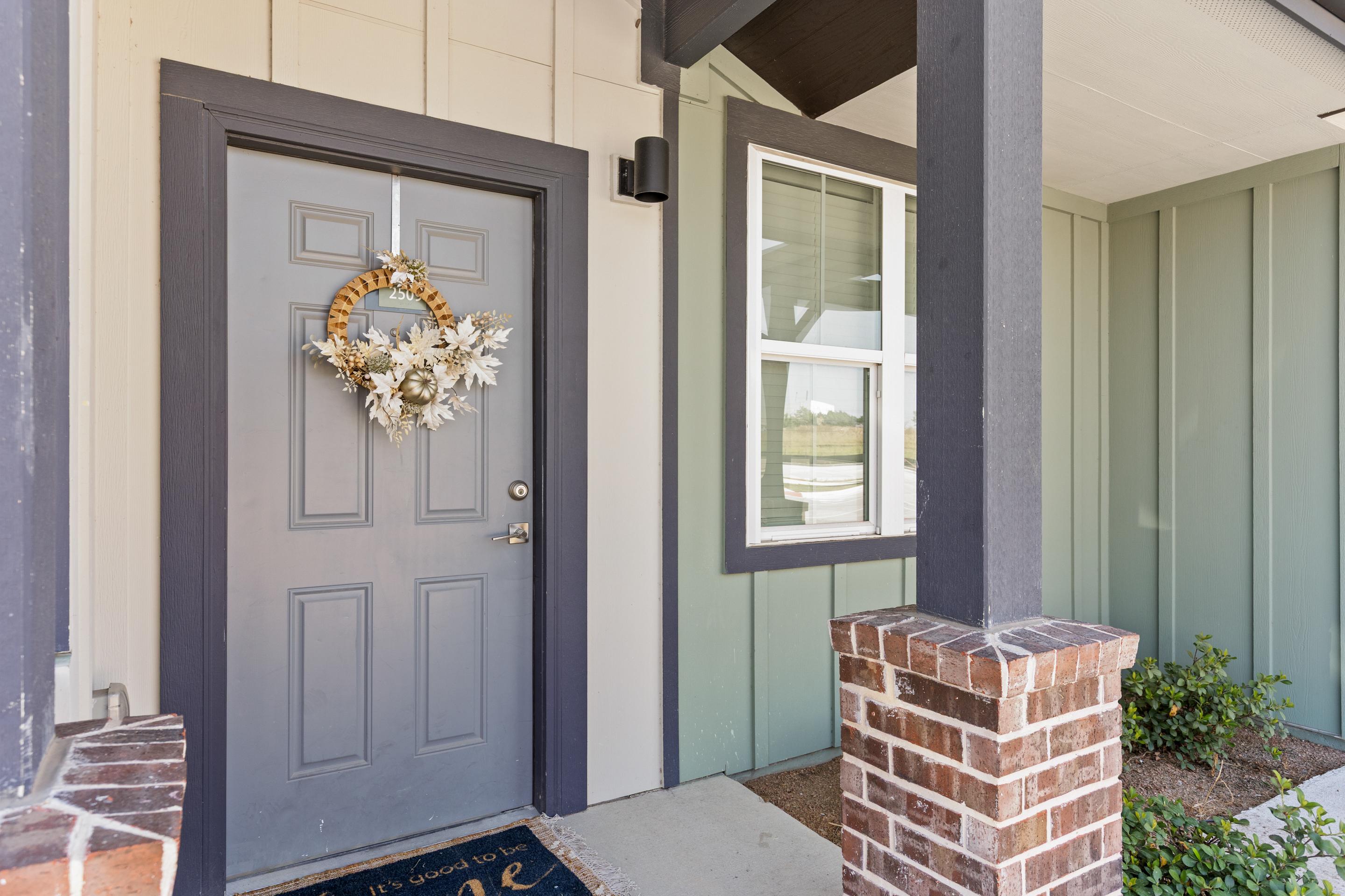 Charming covered entry with modern farmhouse style and welcoming details