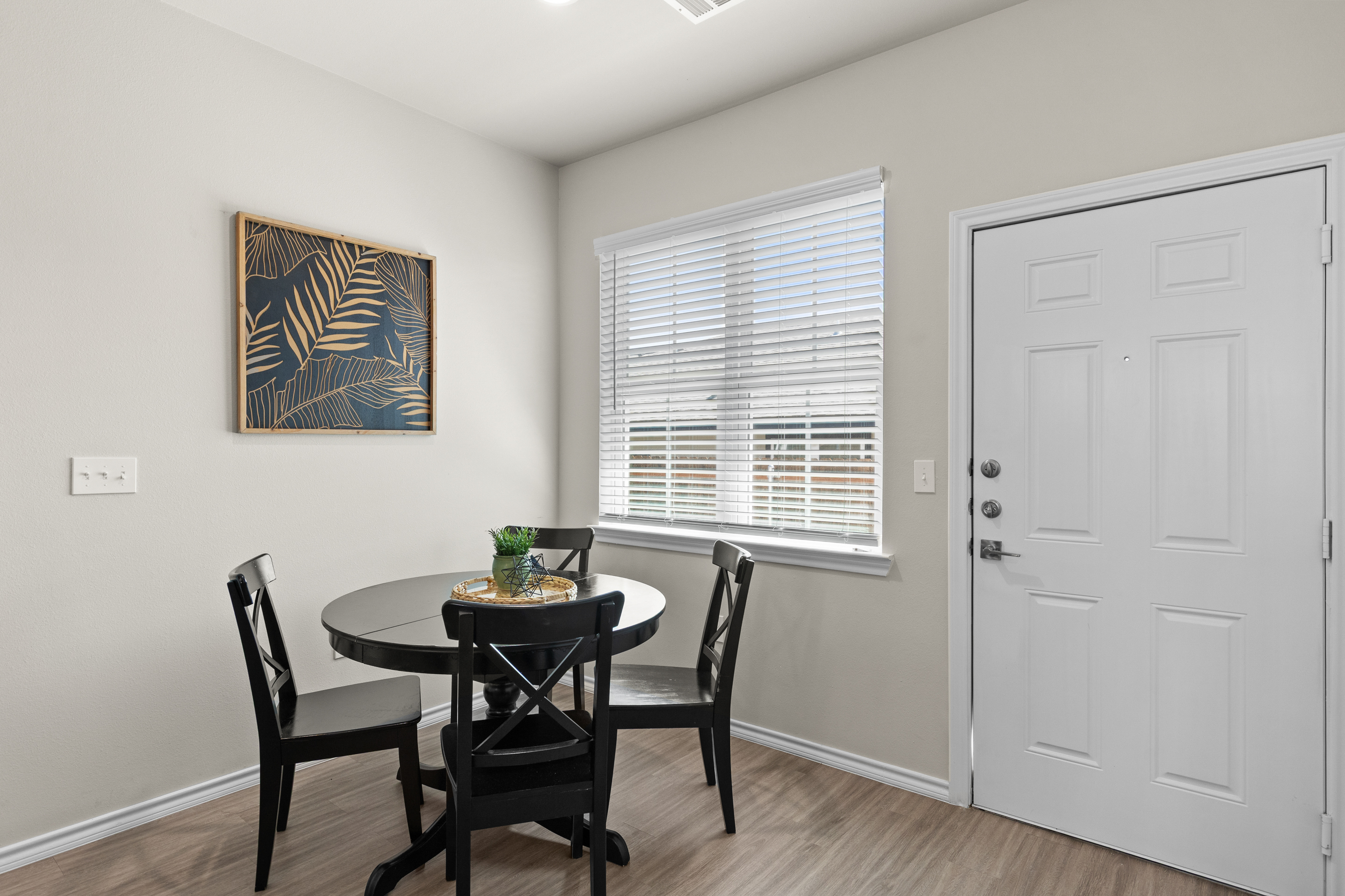 Bright dining nook with natural light and seating for four