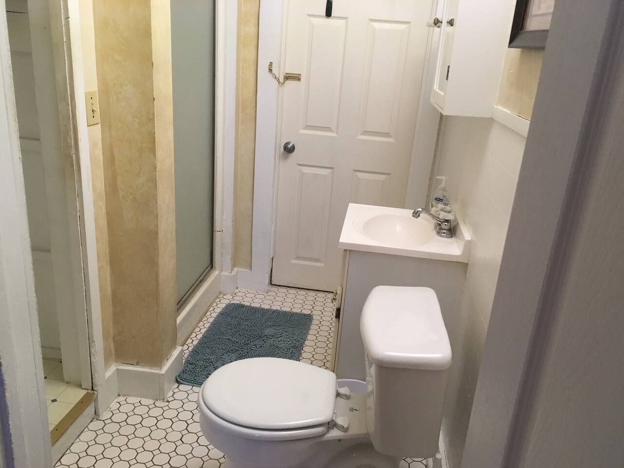 Tiled bath with hot shower, just big enough for one or two.