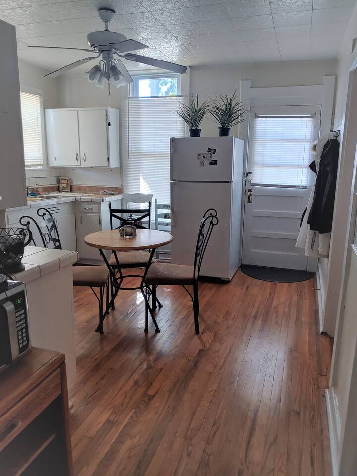 Kitchen table seats 4 . Wood floor is original