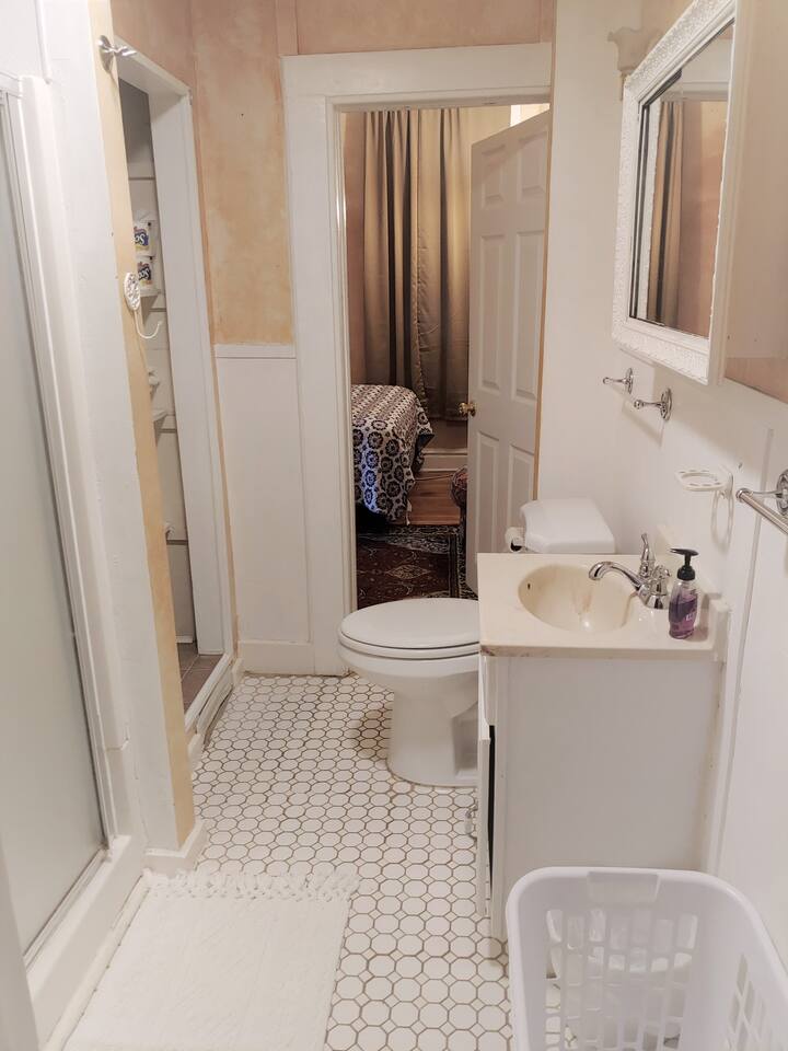 compact and functional bath has a shower for quick hot showers.