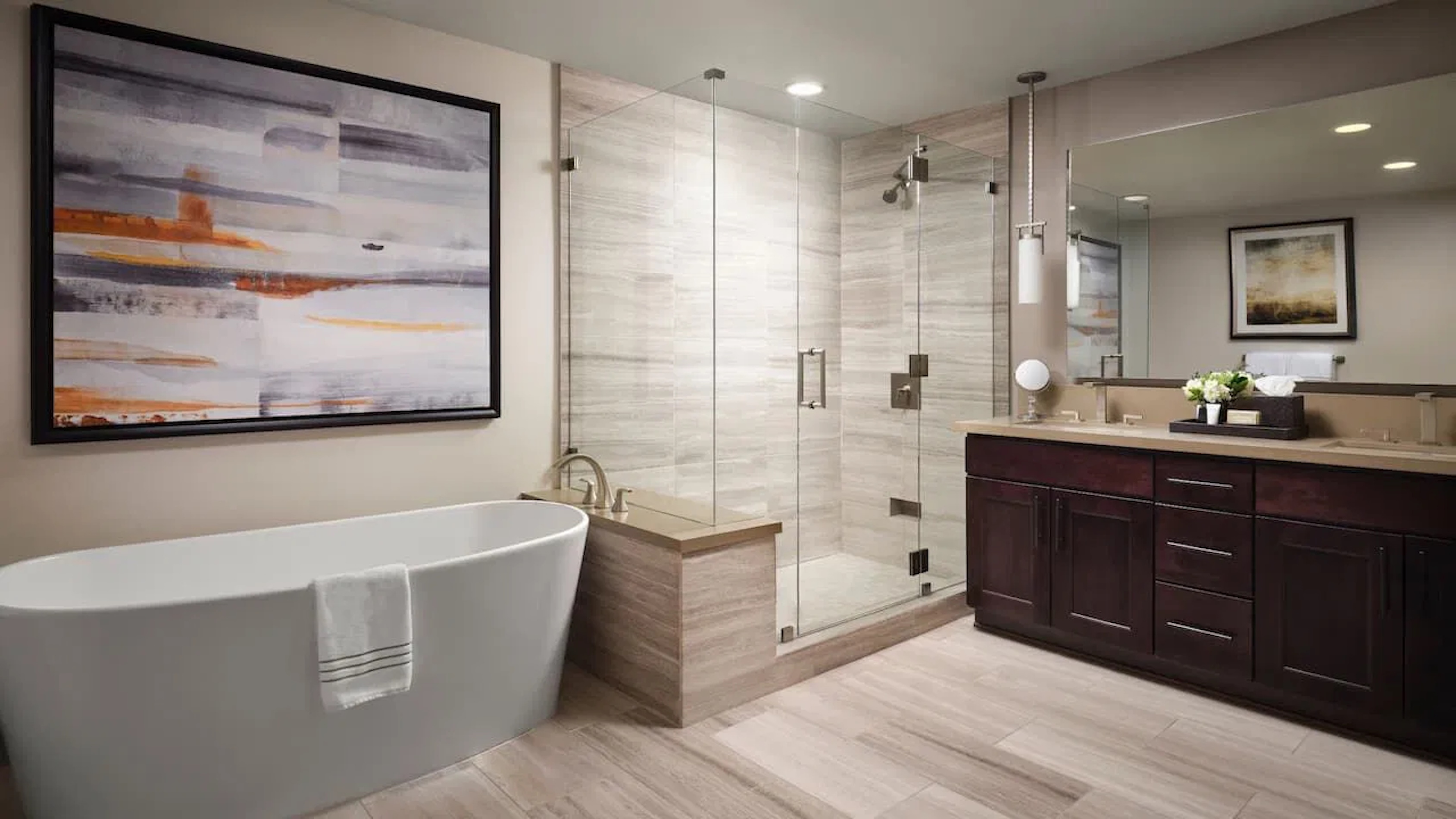 Spa-like bathroom with soaking tub, glass shower, and double vanity