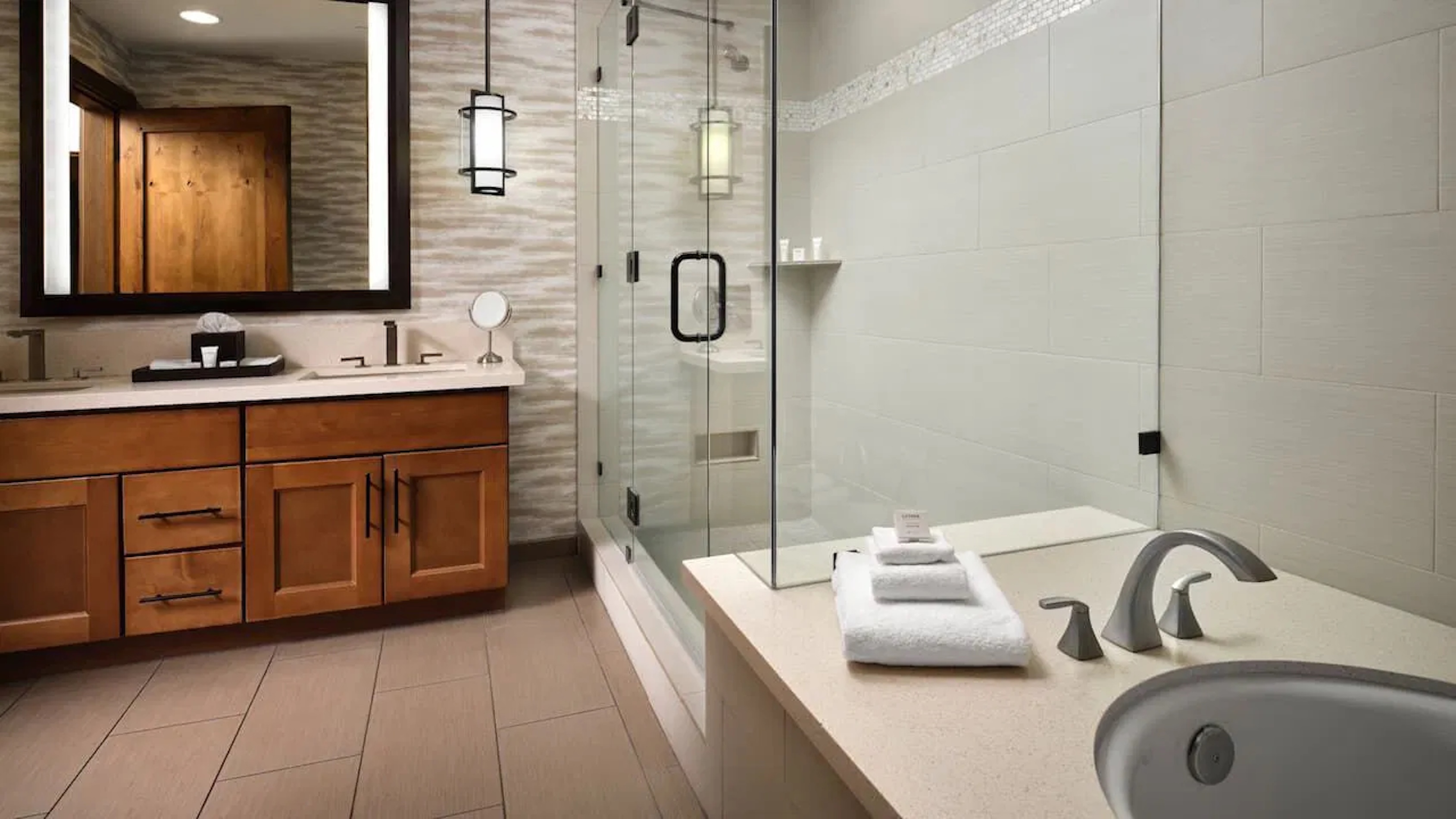 Spa-like bathroom with soaking tub, glass shower, and double vanity