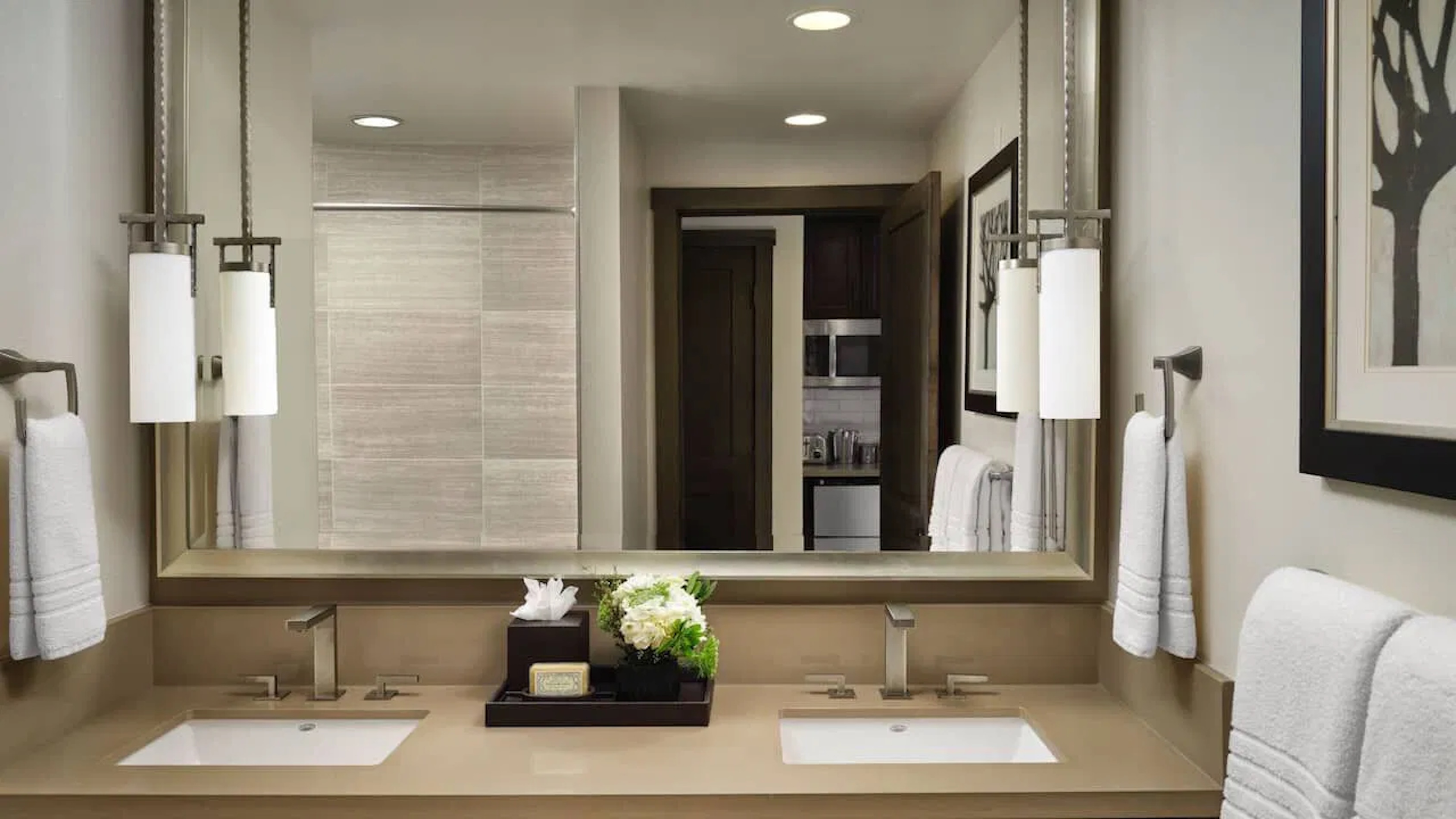 Modern double vanity bathroom with elegant lighting and upscale finishes