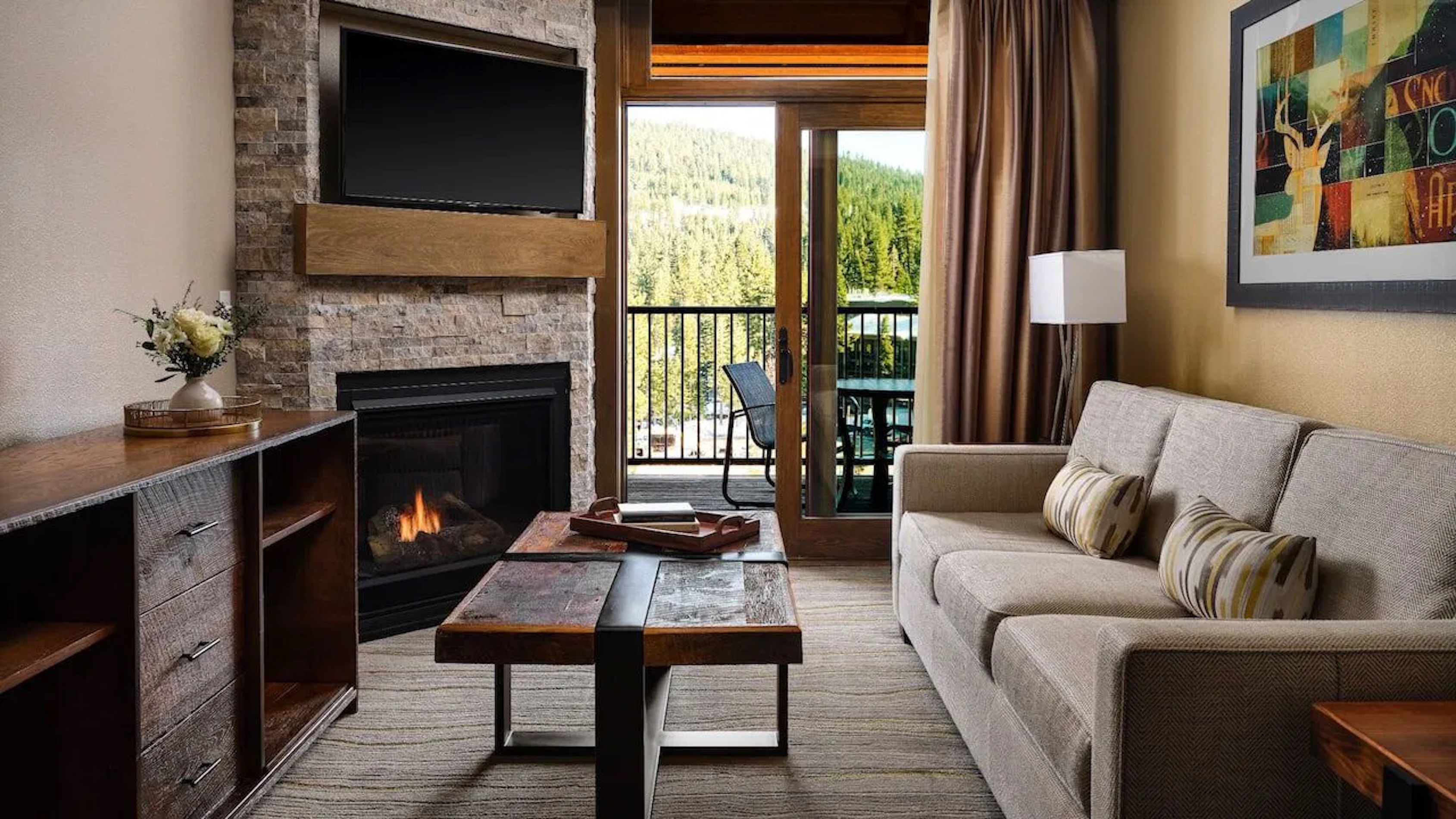 Cozy mountain-view living room with fireplace and private balcony