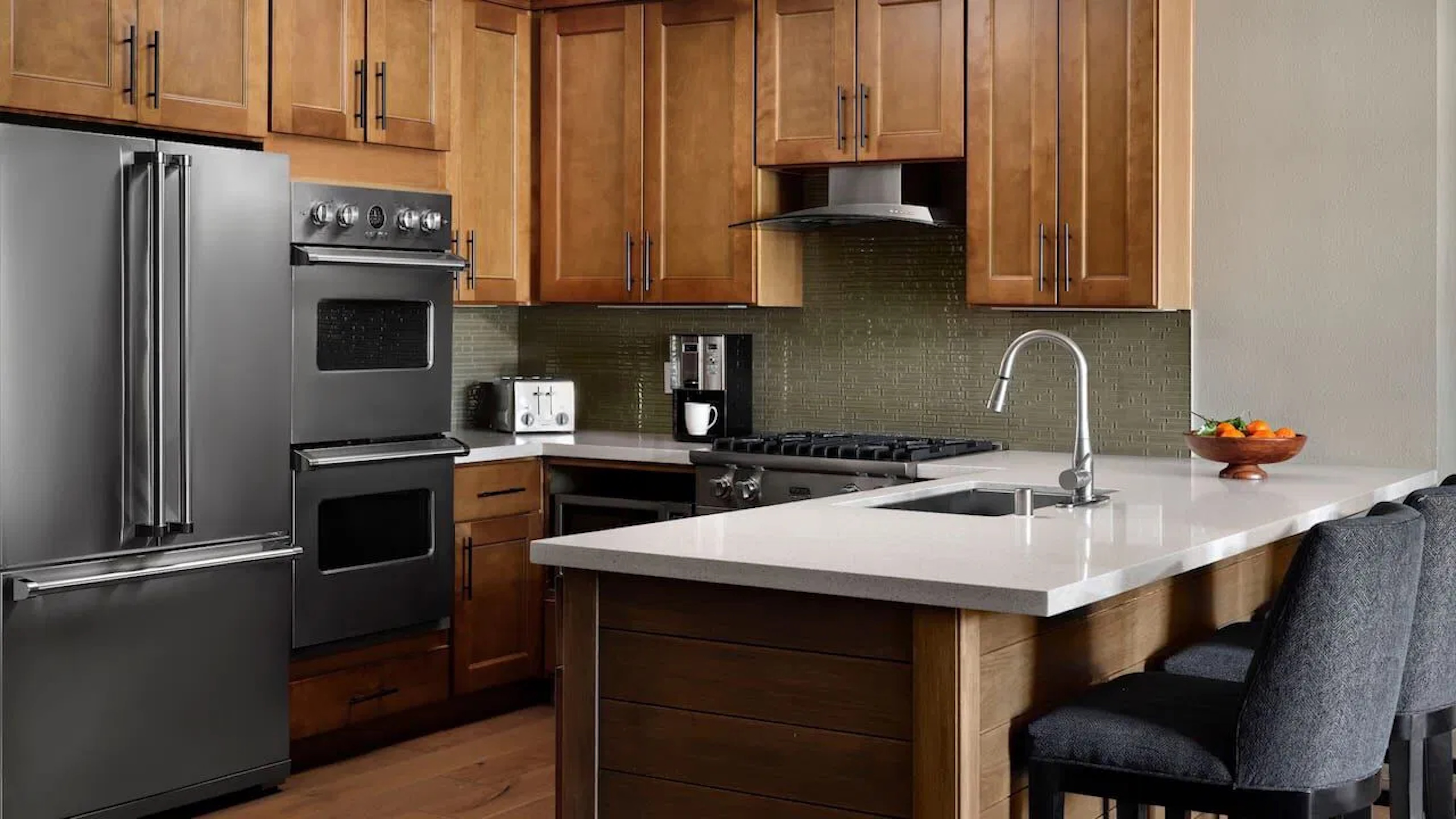 Modern gourmet kitchen with island seating and stainless appliances