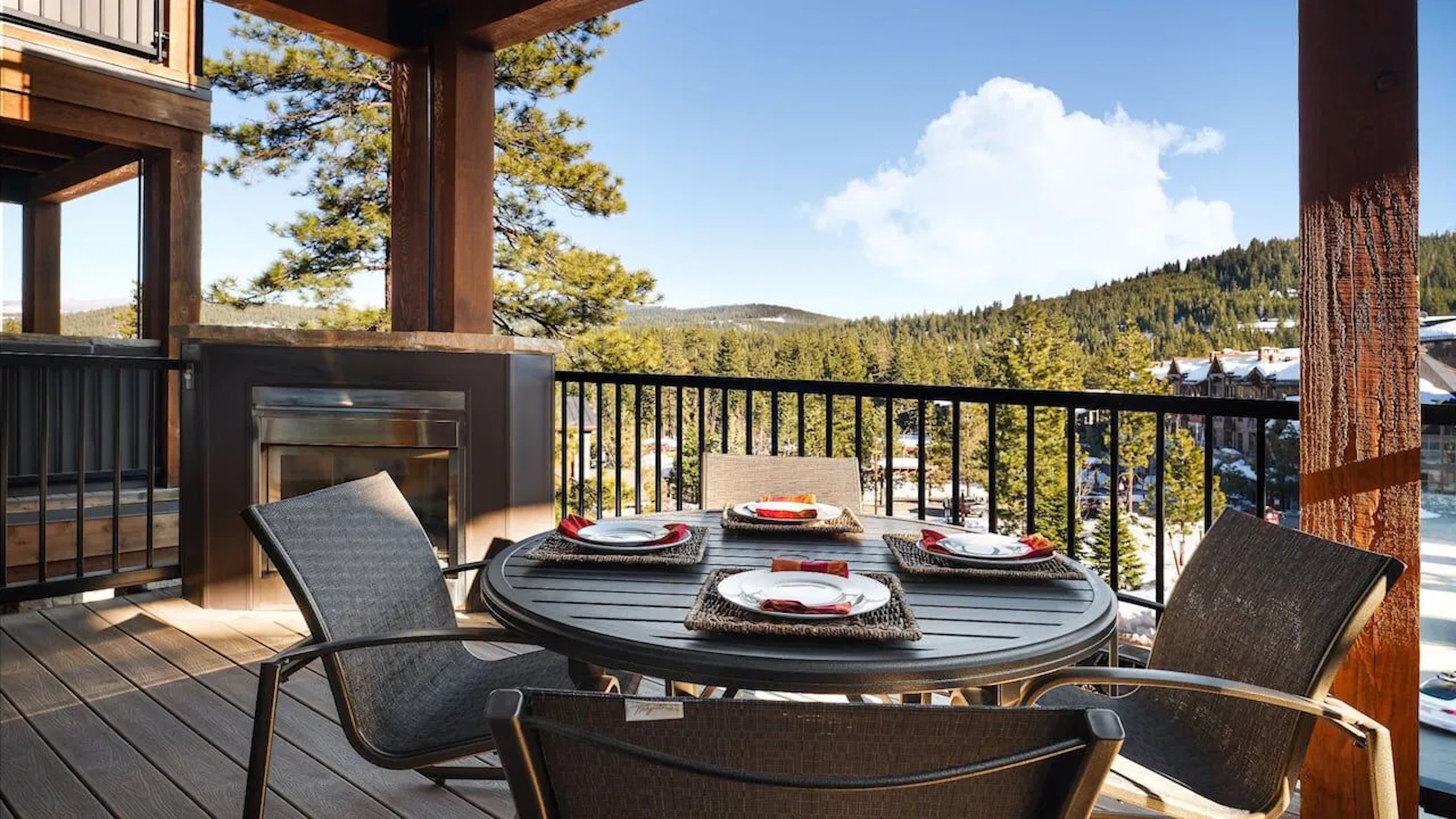 Scenic covered deck with fireplace, dining for 4, and mountain views