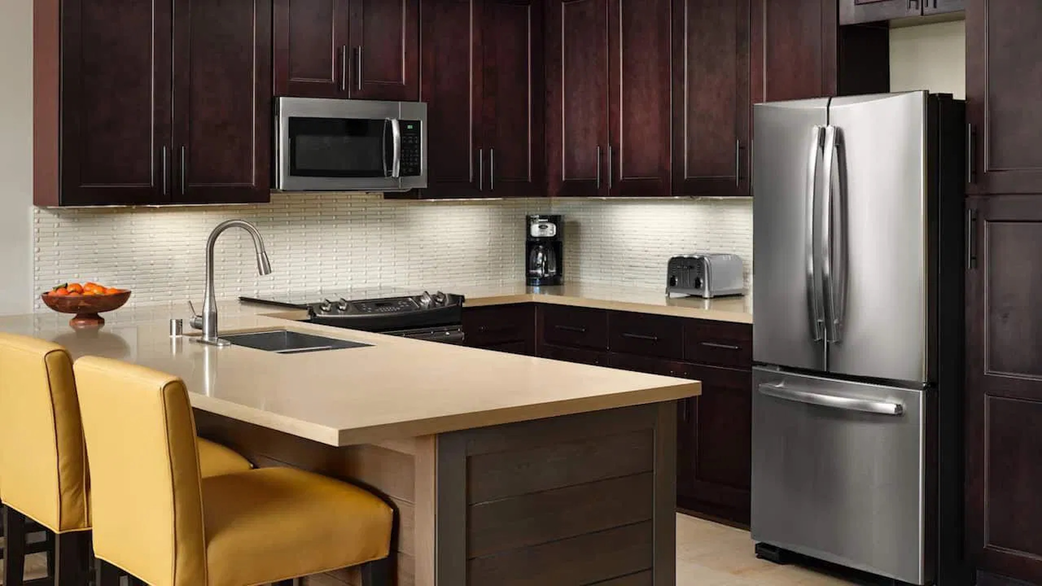 Modern gourmet kitchen with island seating and stainless appliances