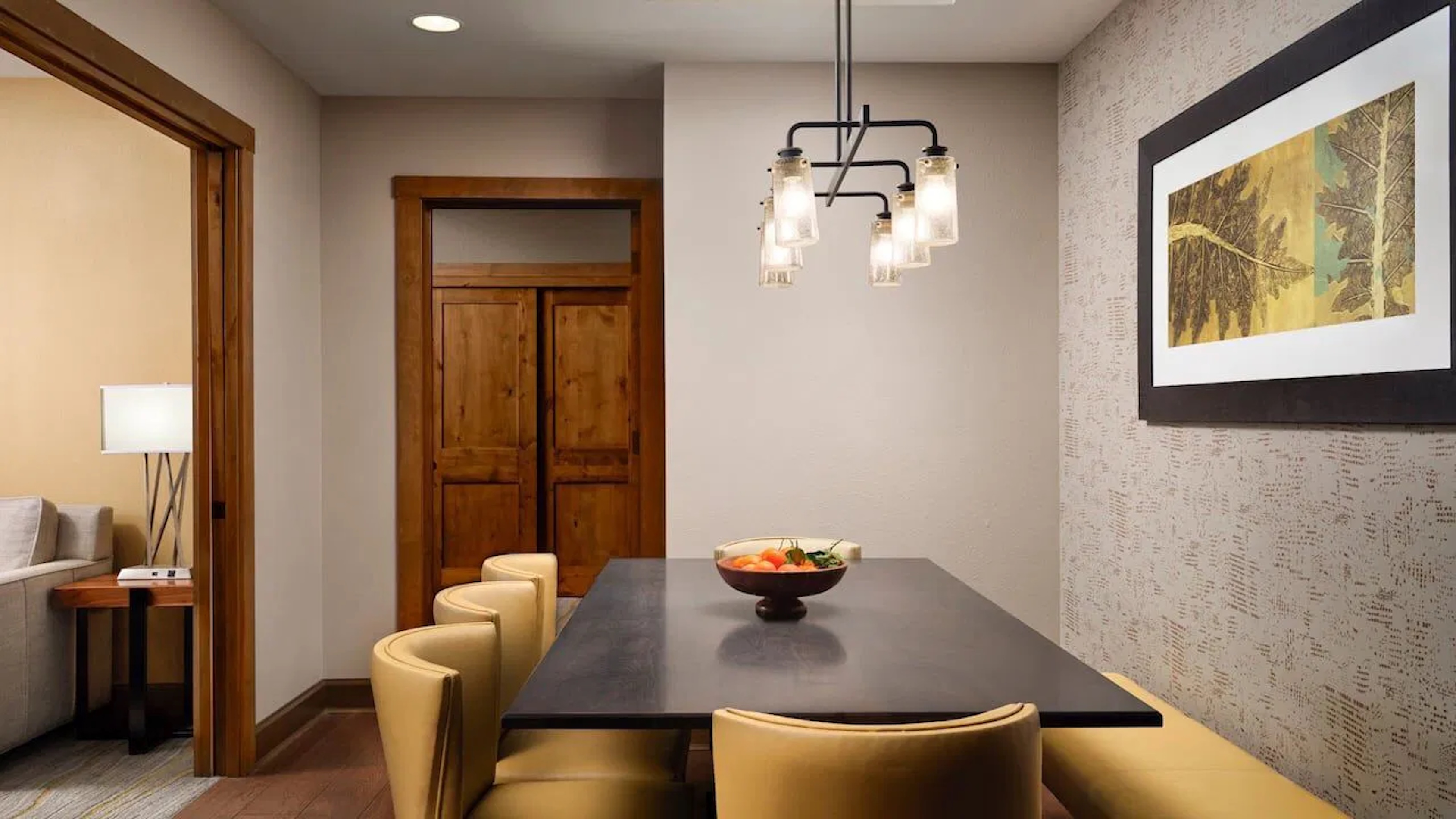 Modern dining nook with warm lighting, upscale finishes, and cozy seating