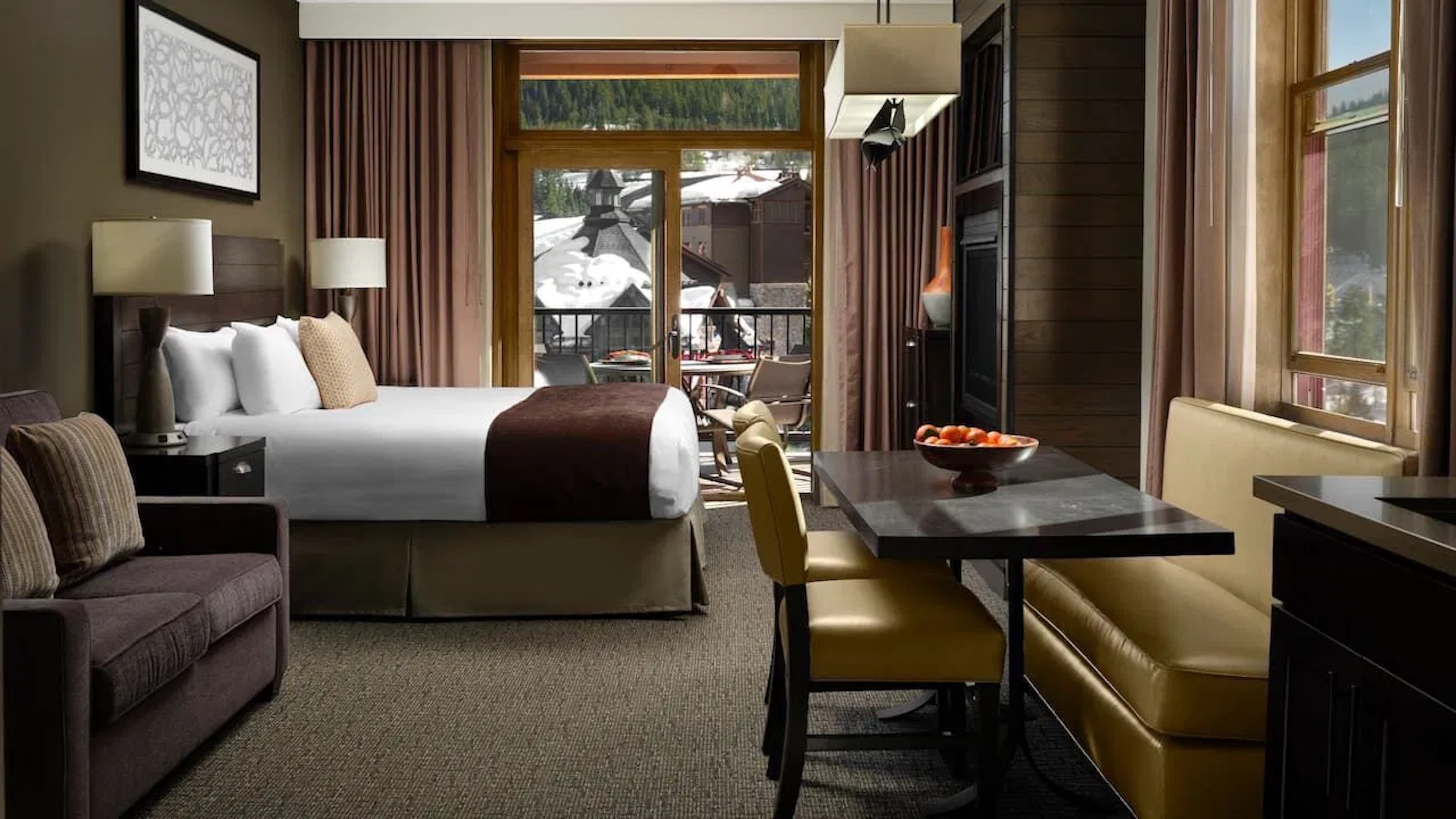 Cozy mountain-view suite with private balcony and dining nook