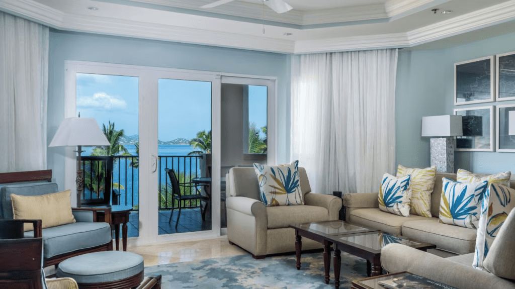 Bright coastal living room with balcony seating and stunning ocean views