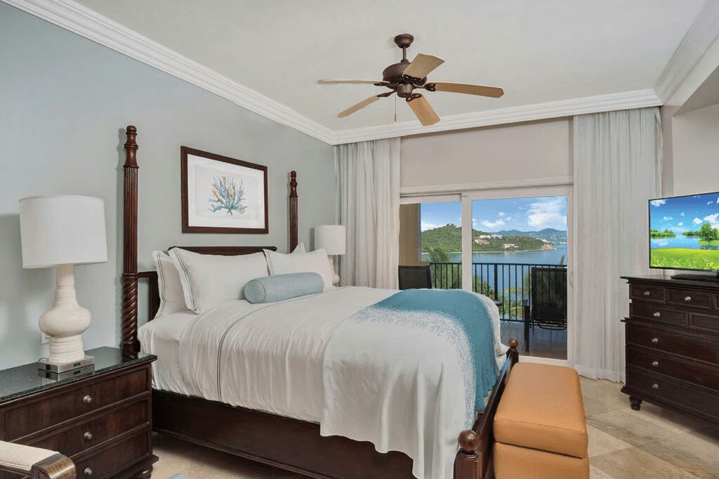 Serene king bedroom with private balcony and stunning water views