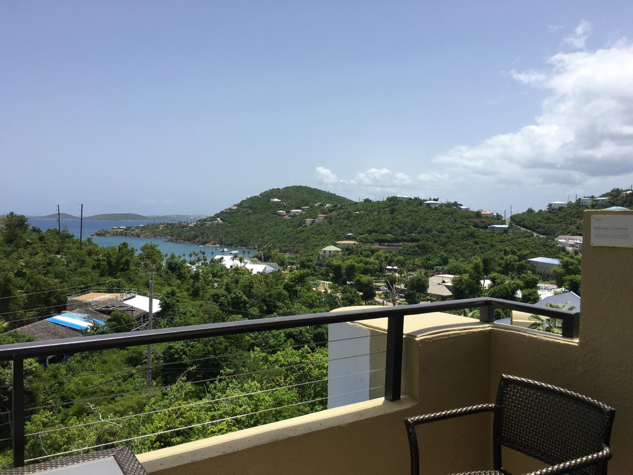 Private balcony with lush hillside and turquoise bay views