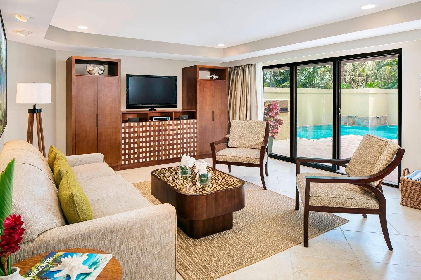 Bright tropical living room with pool views and easy indoor-outdoor access