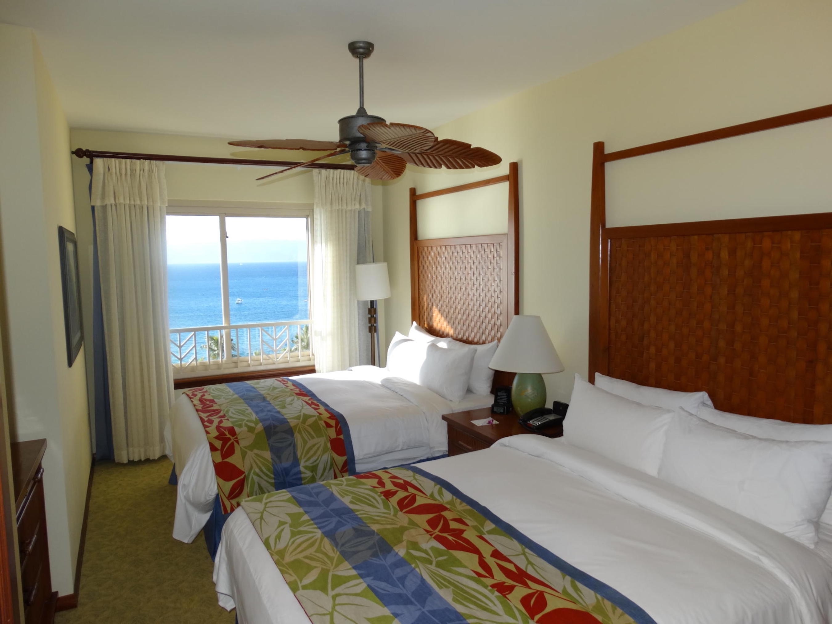 Bright double room with tropical décor and private ocean-view balcony