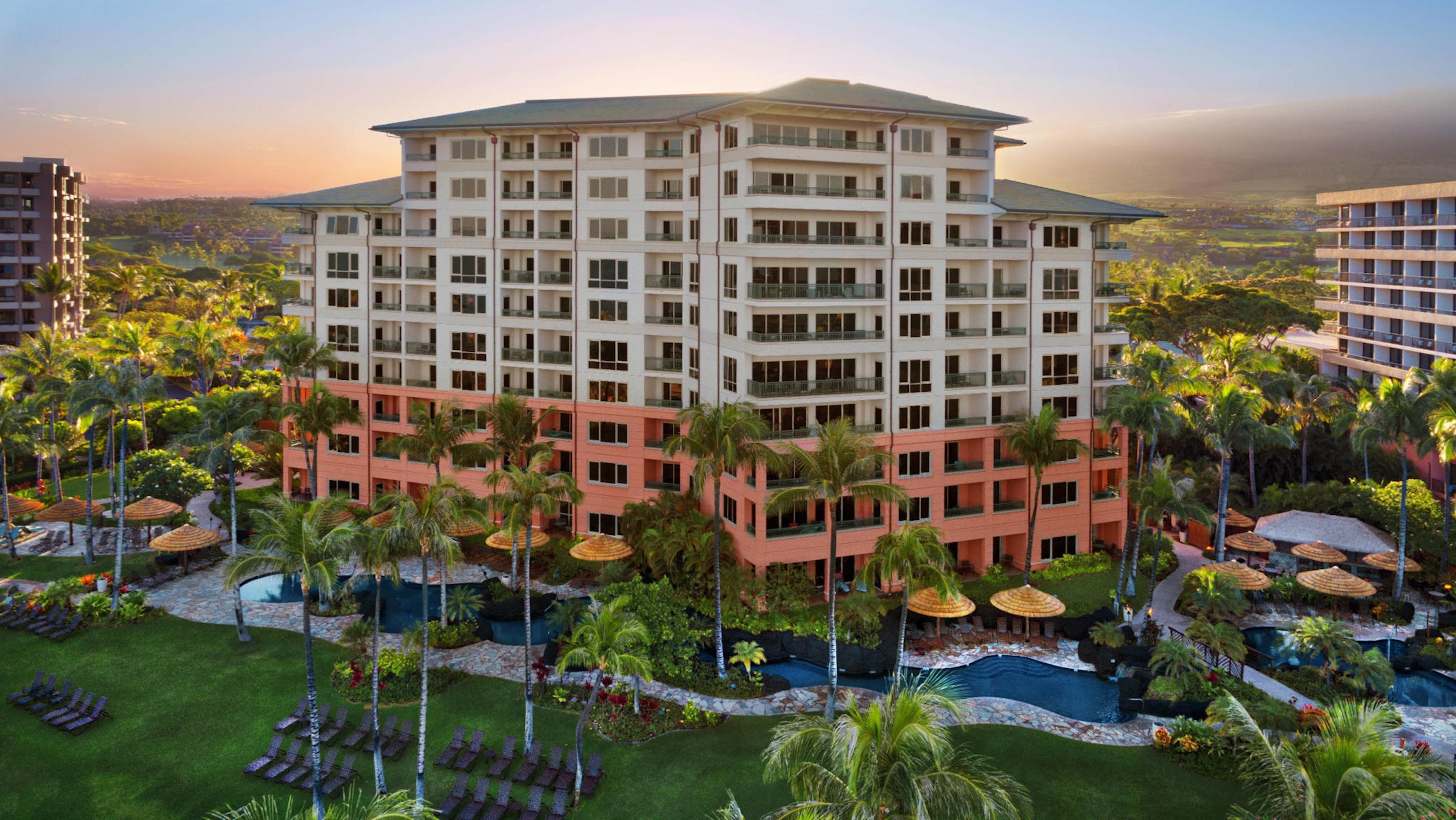 Tropical resort escape with pools, palms, and stunning sunset ambiance