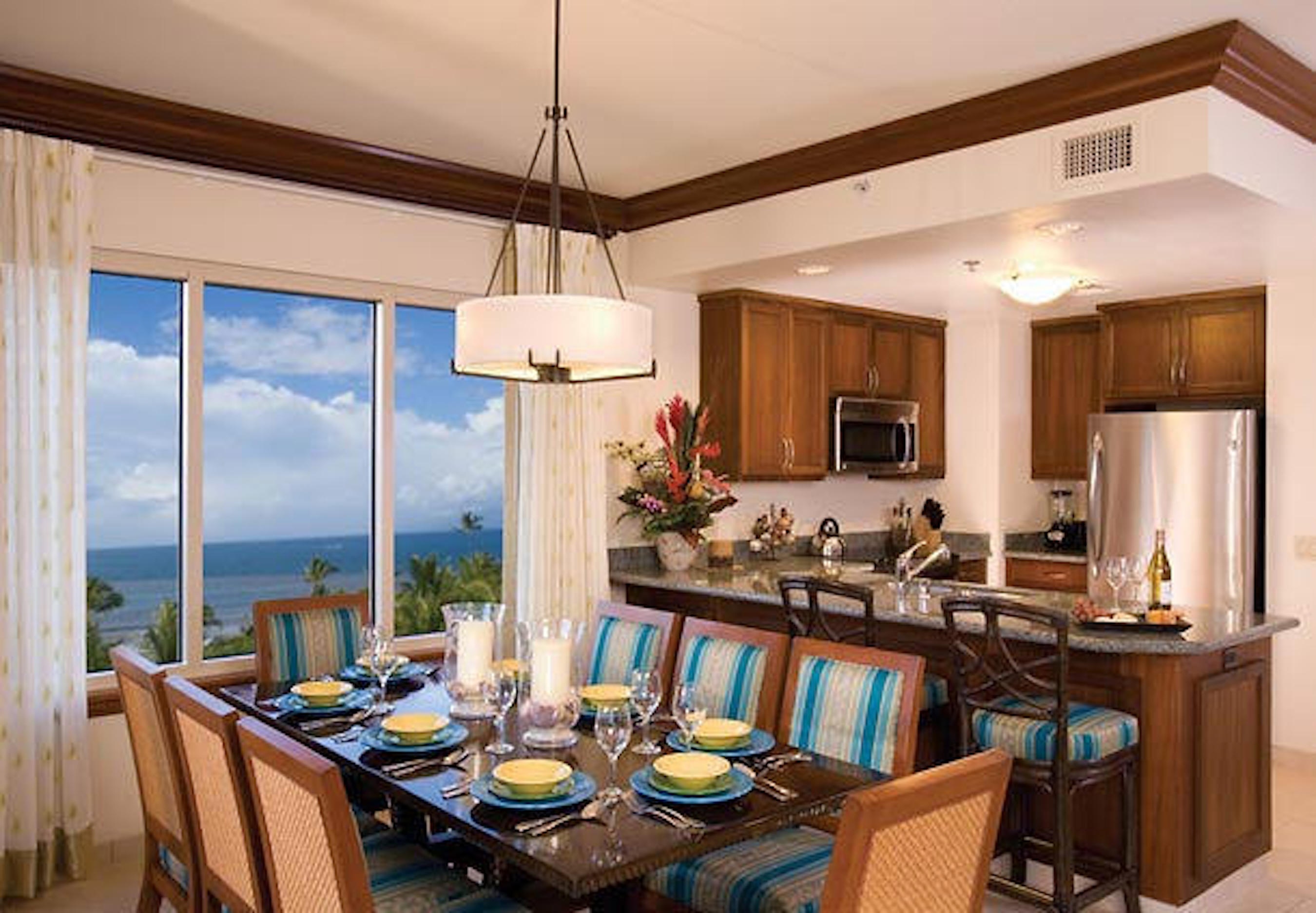 Ocean-view dining and full kitchen with elegant island seating
