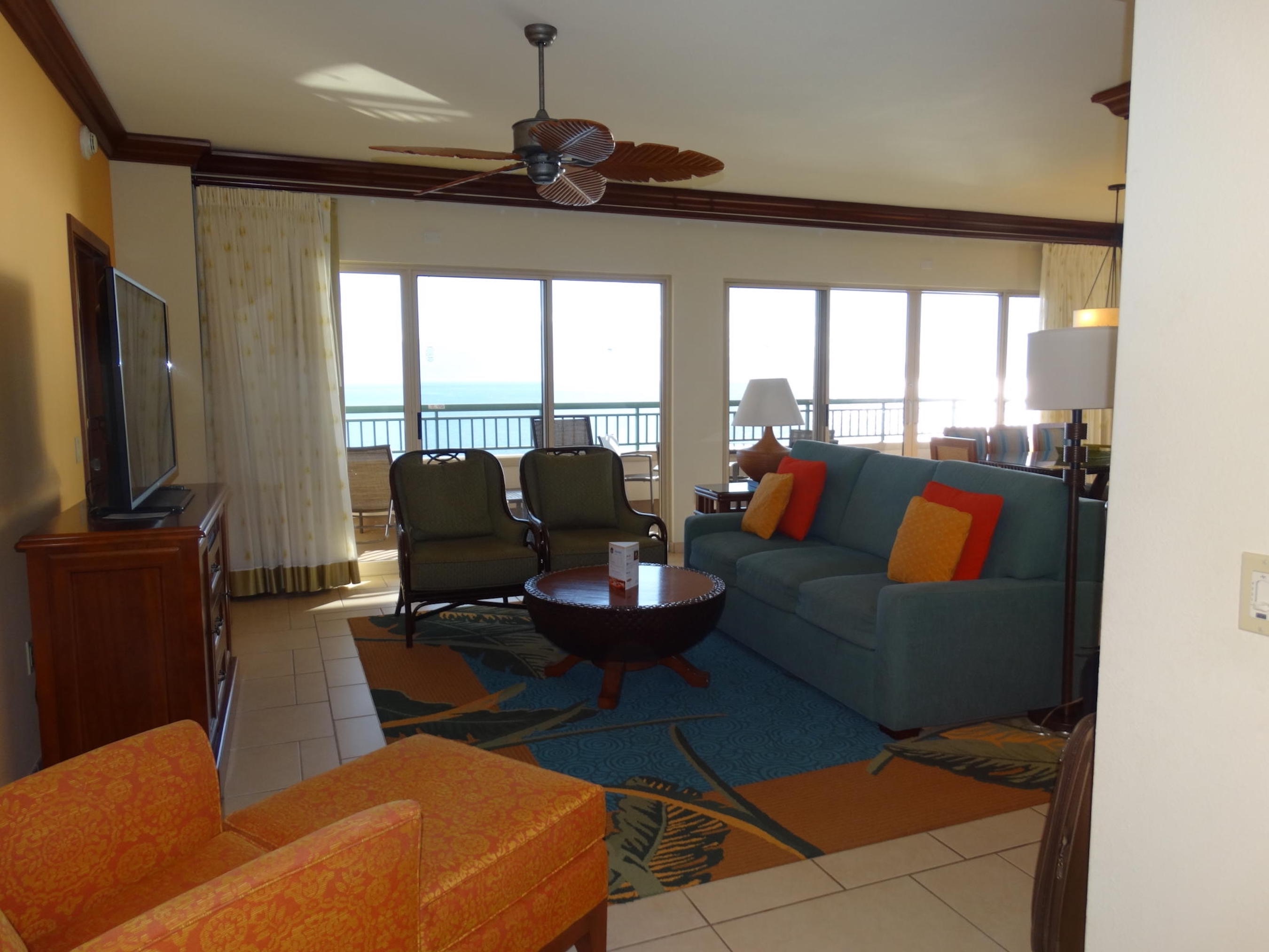 Bright coastal living room with balcony access and ocean views