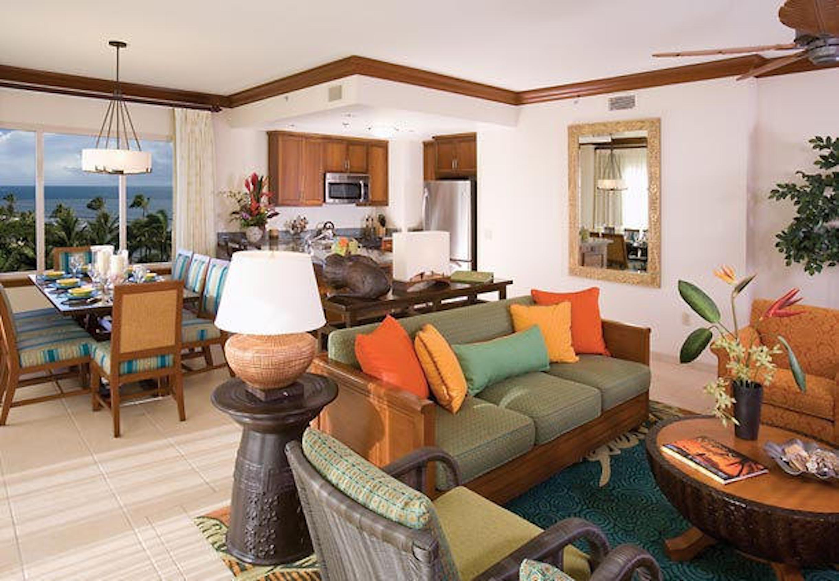 Bright tropical living space with ocean views, dining area, and full kitchen