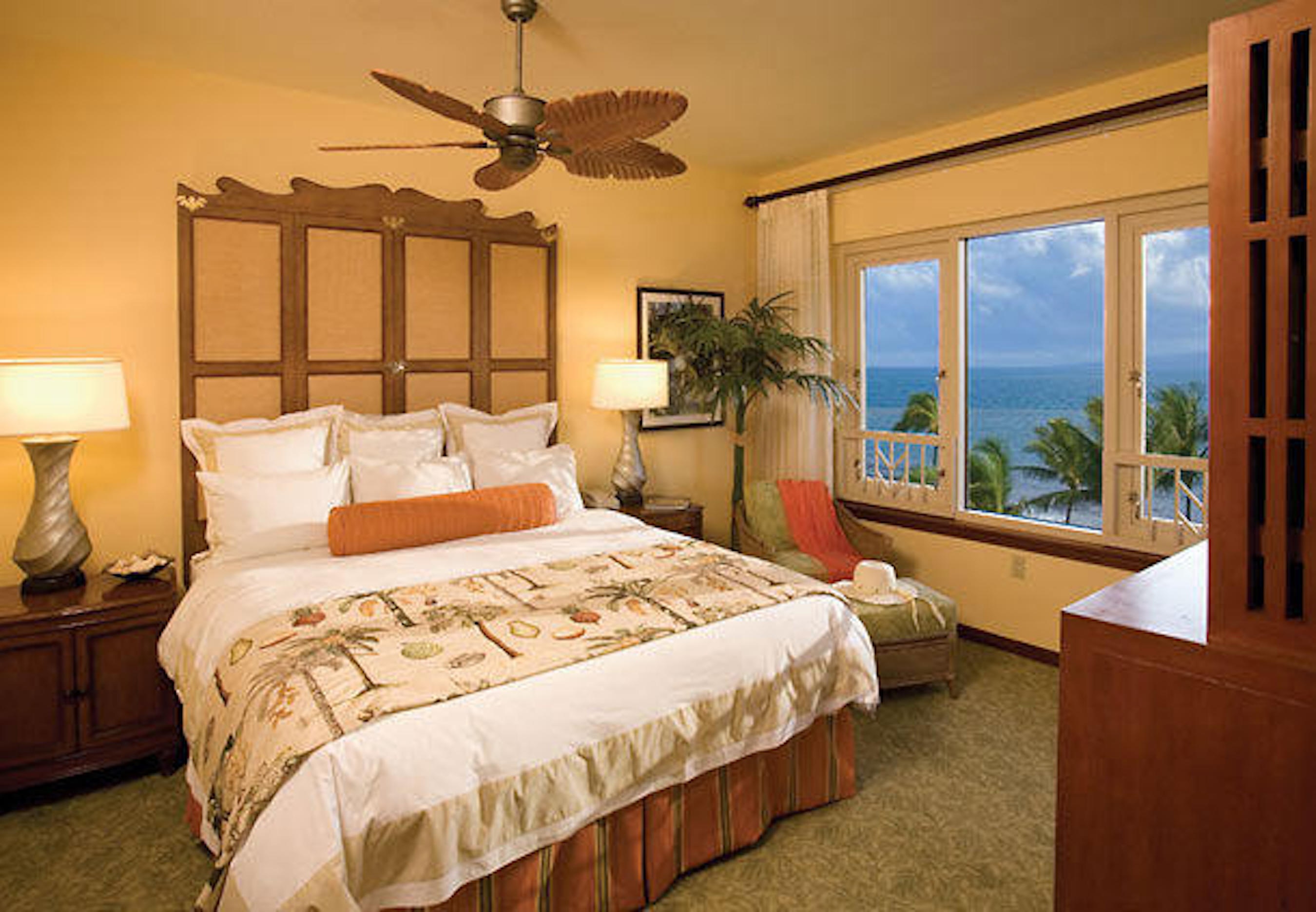 Cozy island-style bedroom with king bed and stunning ocean views