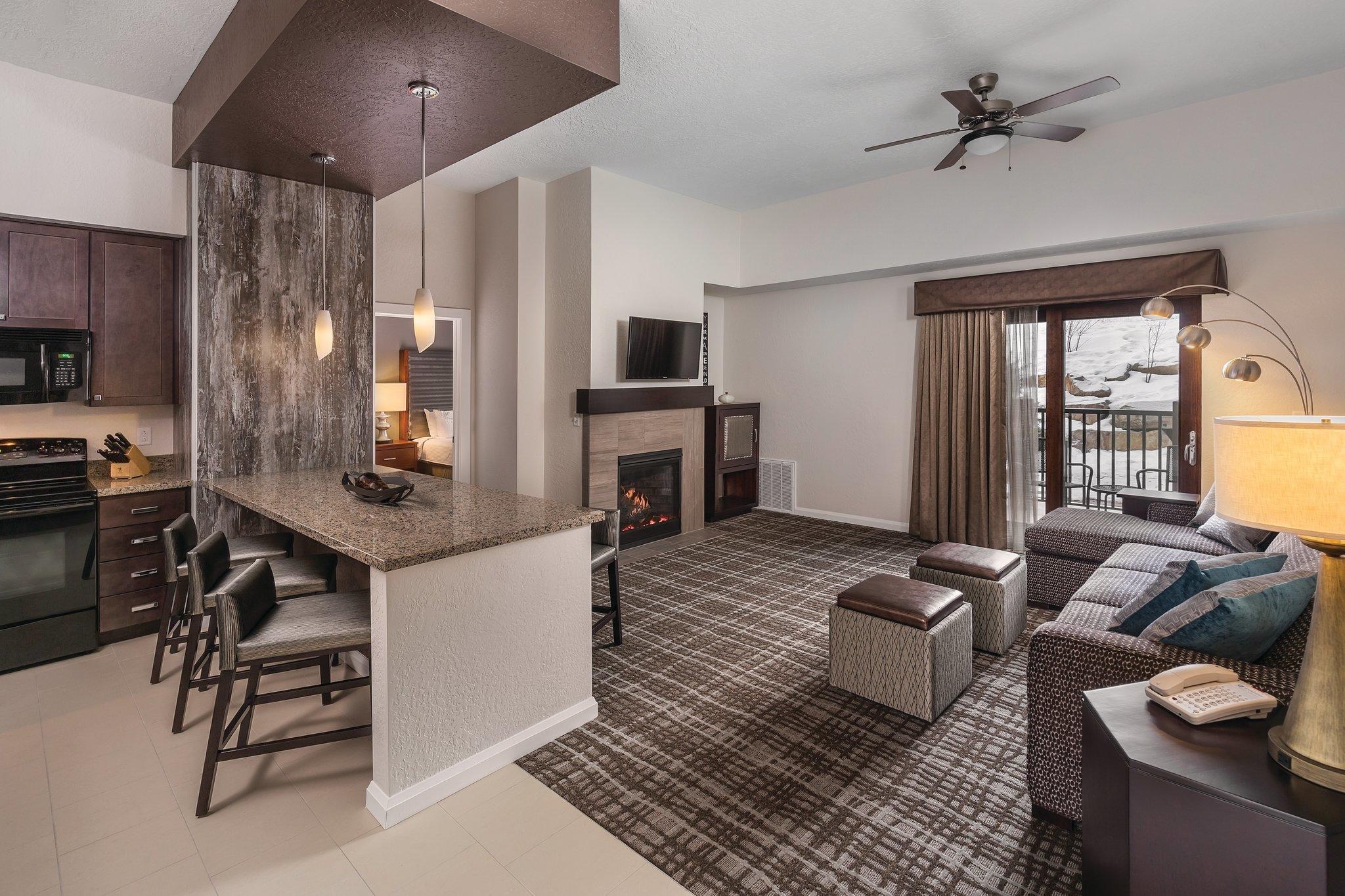Cozy condo living with fireplace, breakfast bar, and private balcony