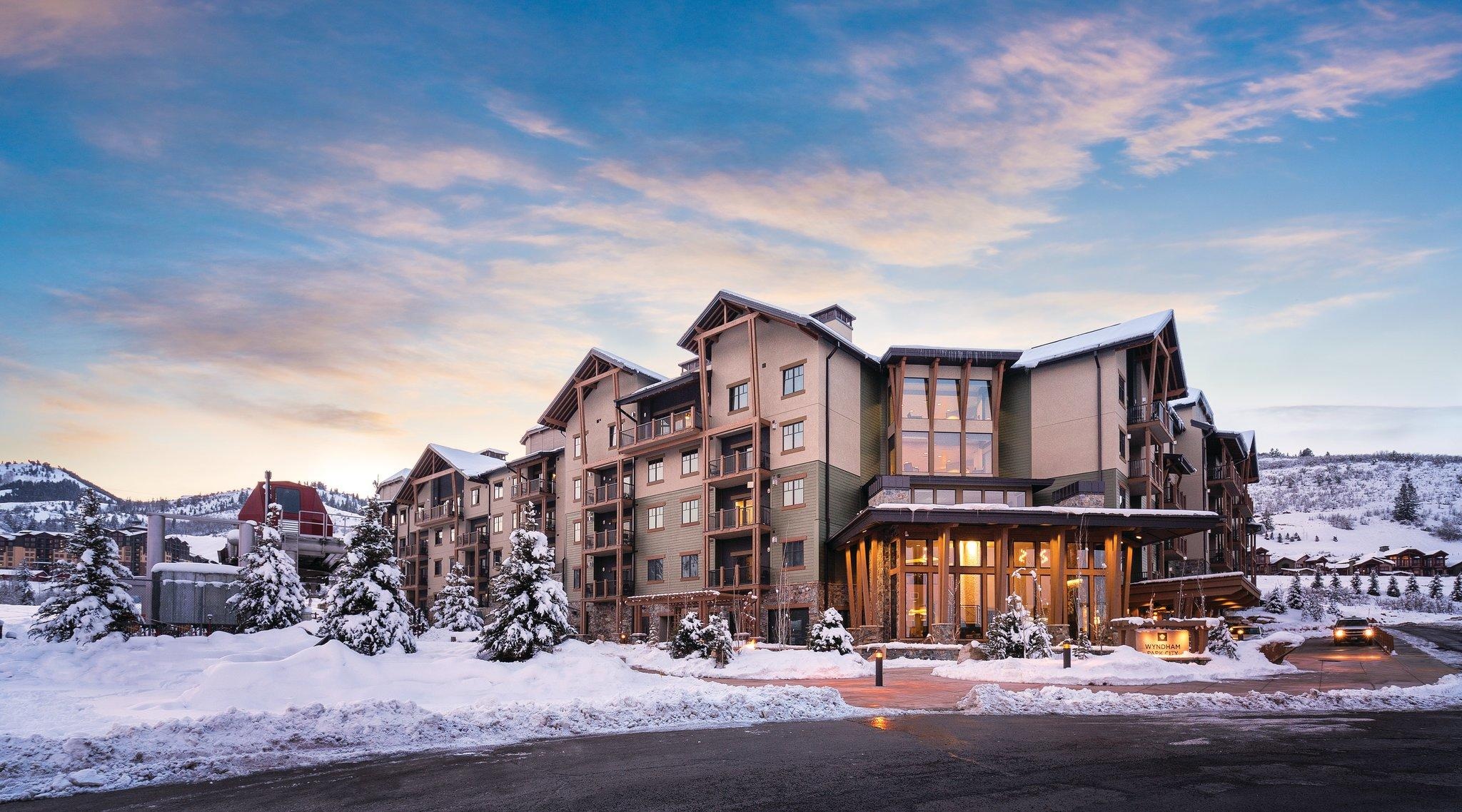 Warm, upscale mountain lodge with snowy views at sunset