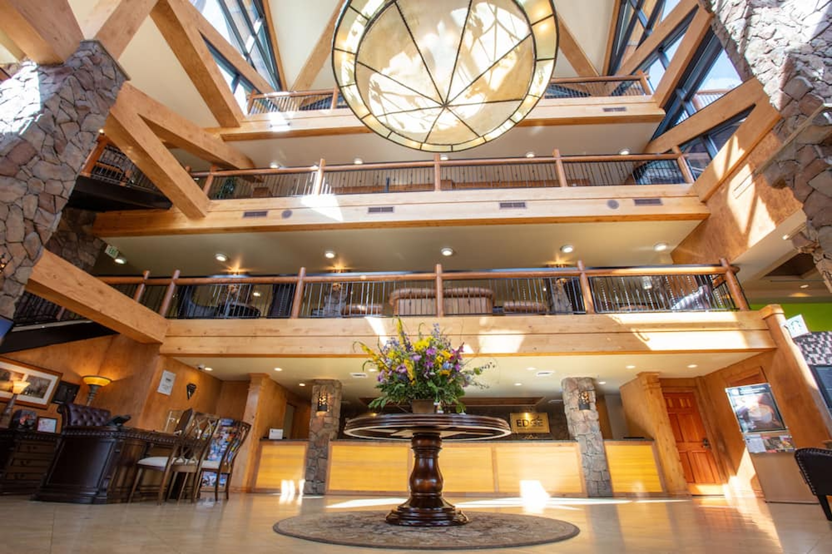 Grand timber-and-stone lobby with soaring ceilings and upscale lodge charm