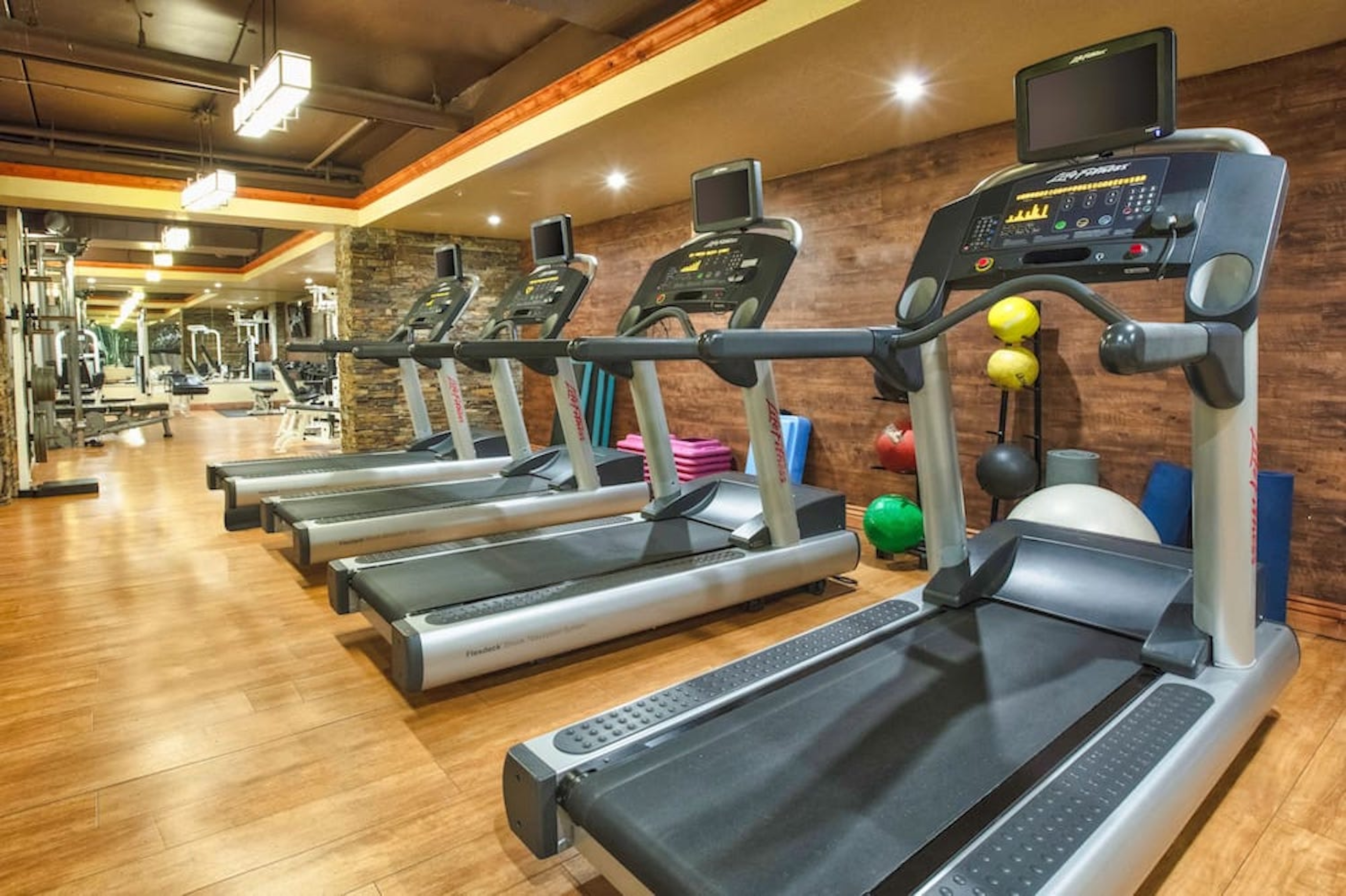 Modern fitness center with treadmills, weights, and spacious workout area