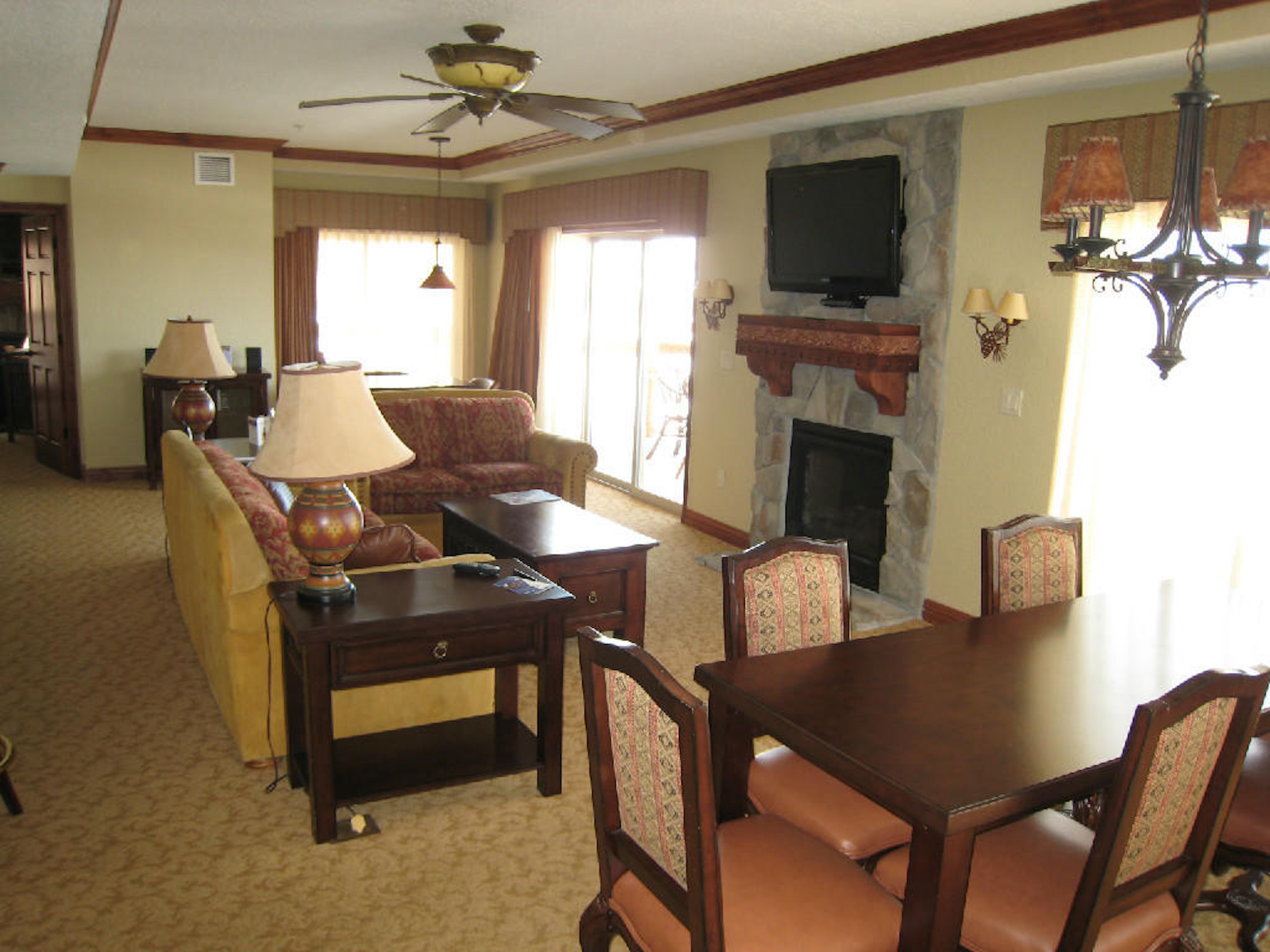 Spacious living area with fireplace, dining space, and bright natural light