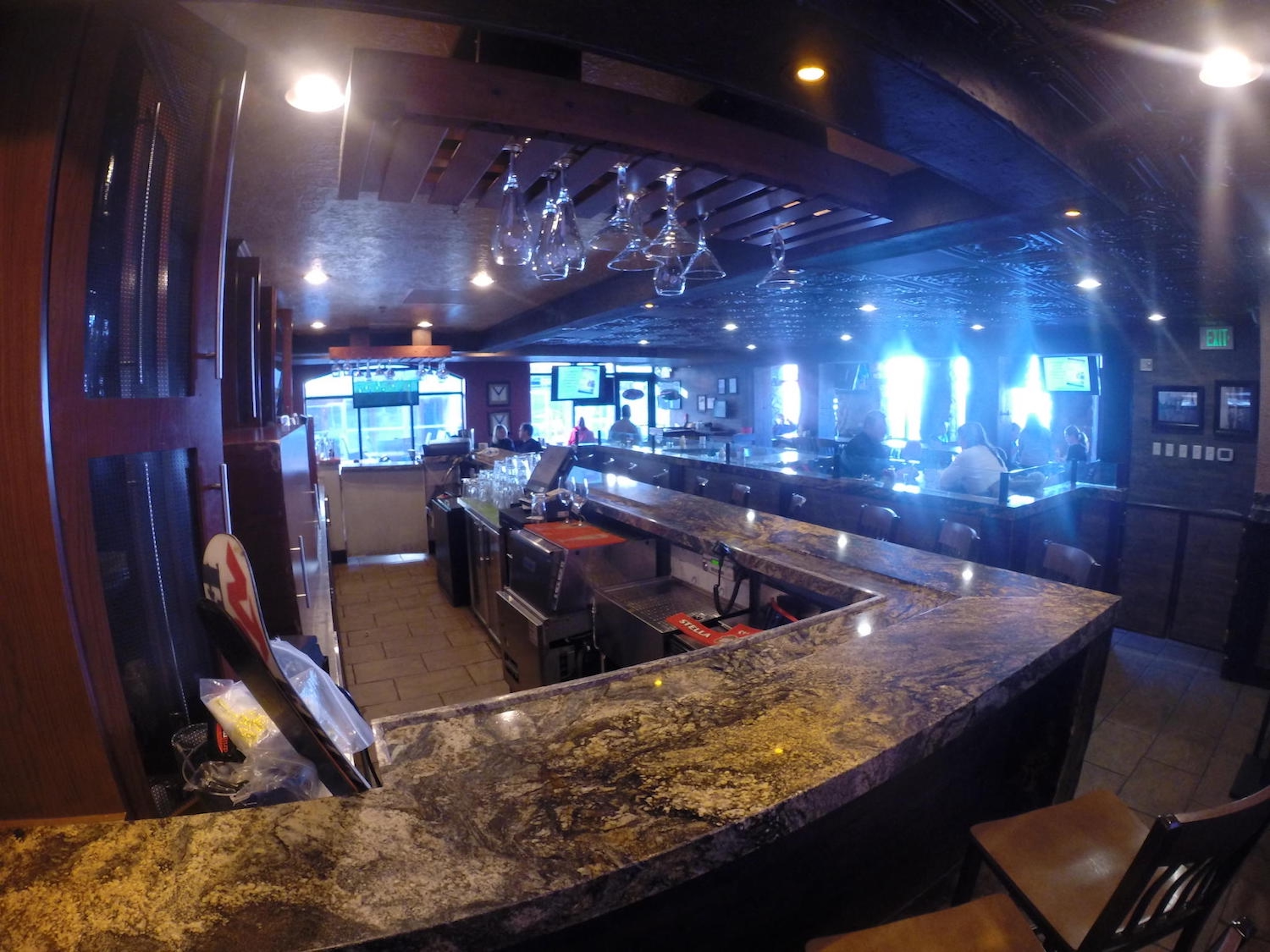 Spacious upscale bar with stone counters and warm lounge-style ambiance