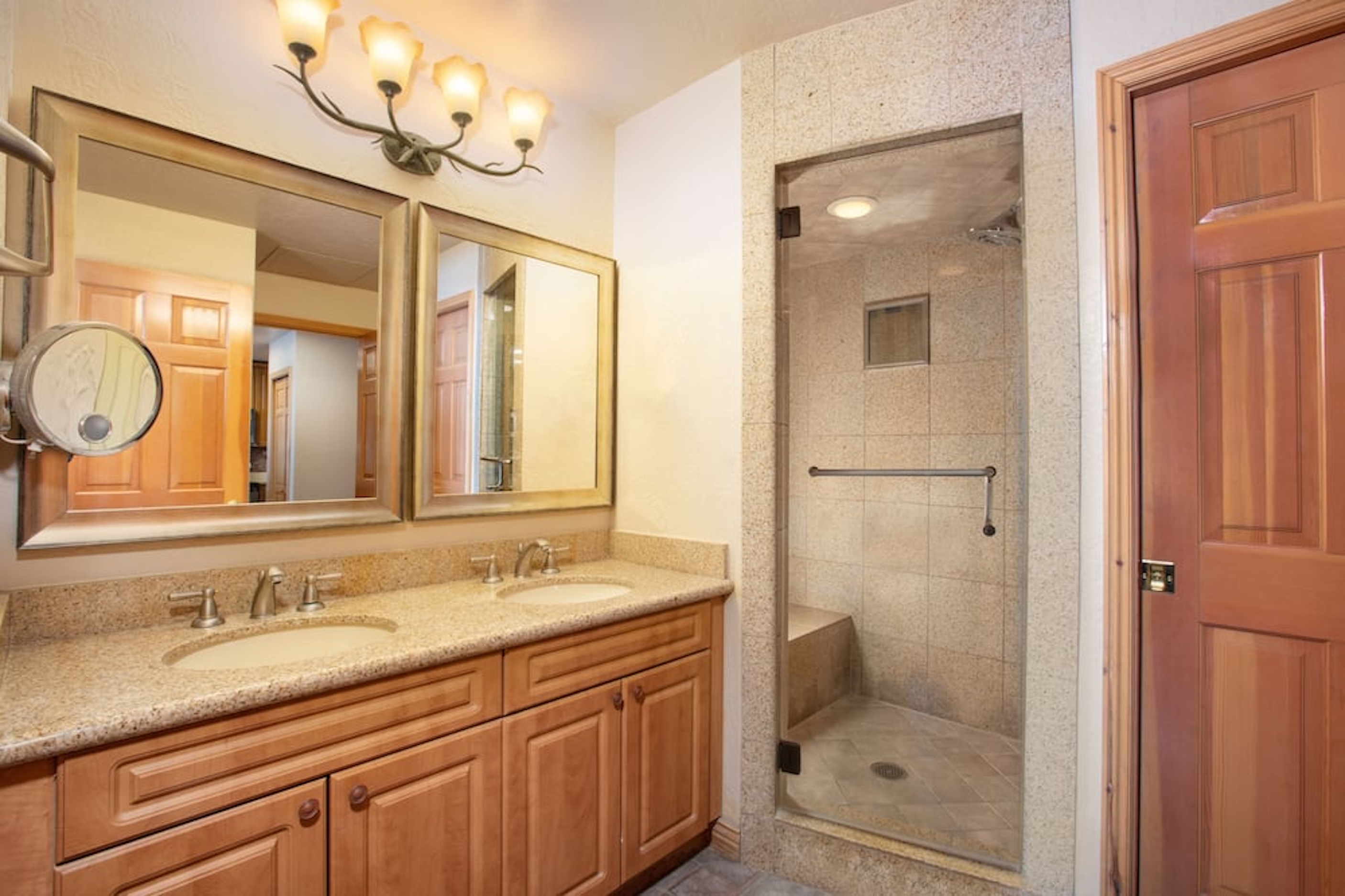 Spa-like bathroom with double vanity and large walk-in glass shower
