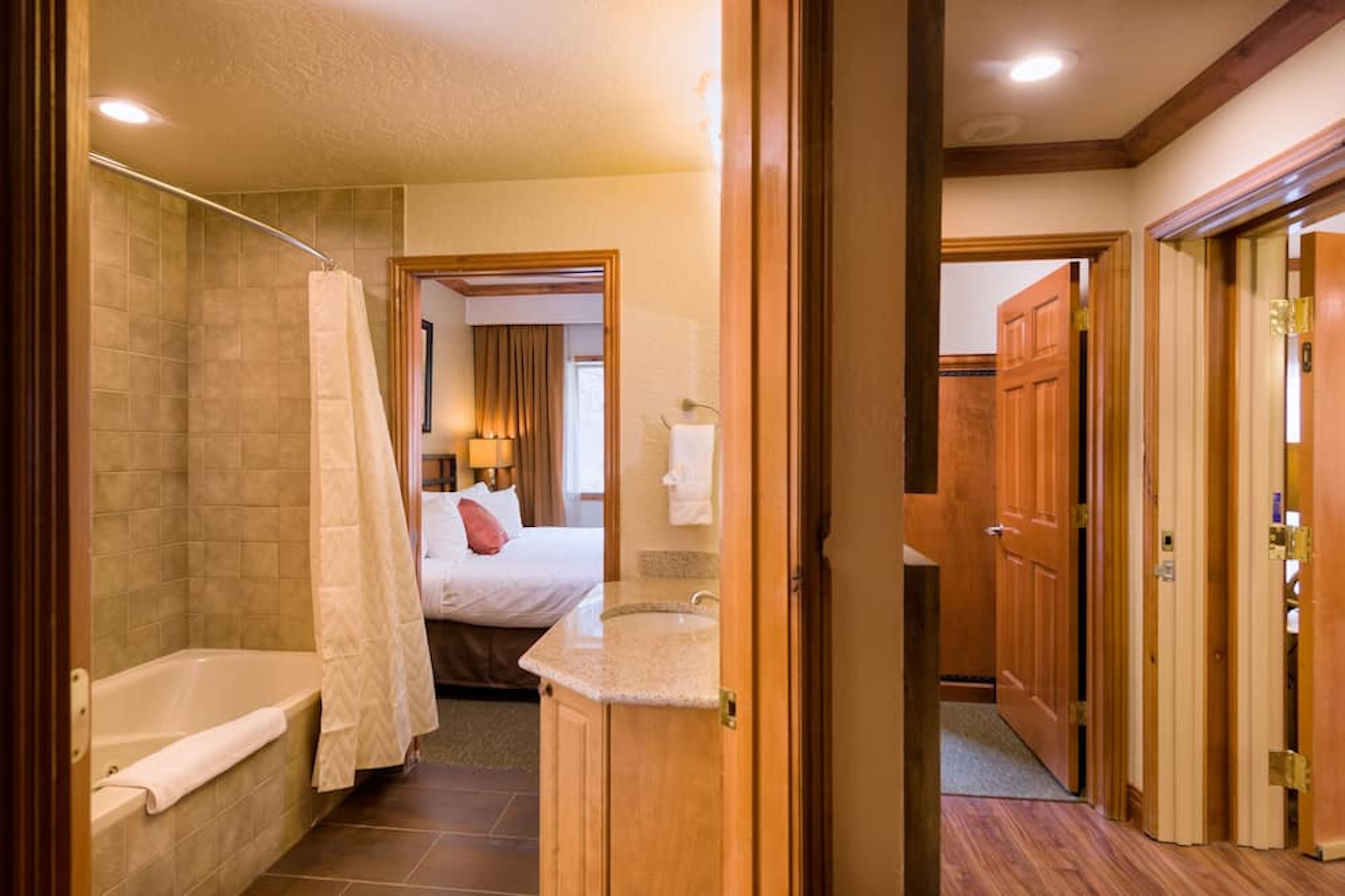 Suite-style bath with granite vanity and direct bedroom access