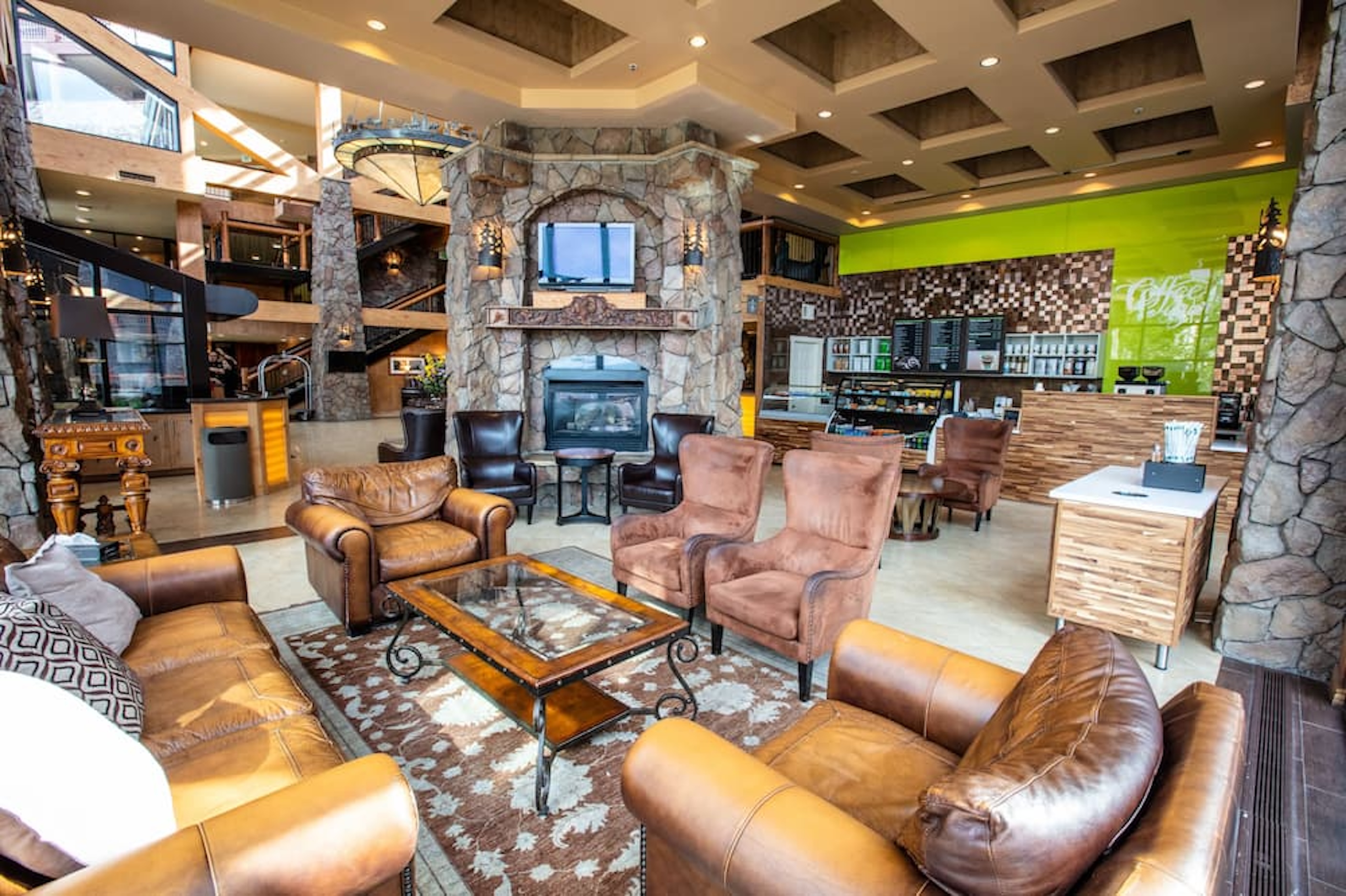 Grand lodge-style lobby with stone fireplace and cozy lounge seating