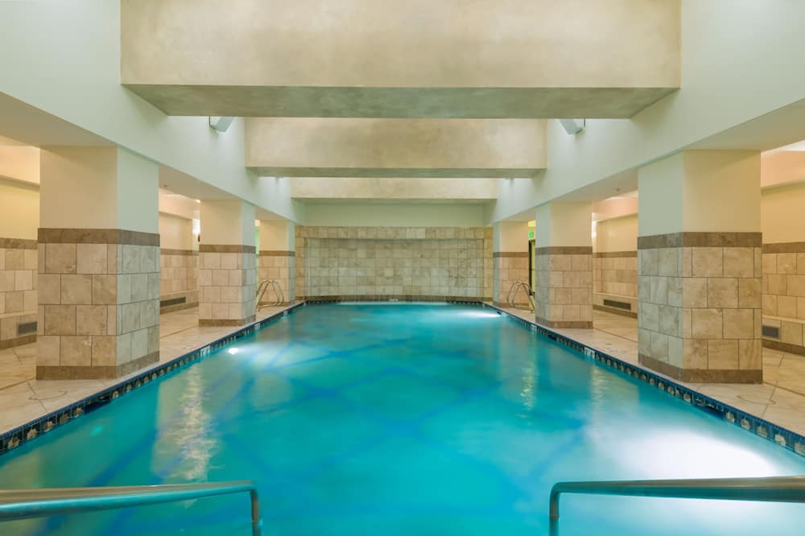 Spacious indoor pool with a serene, resort-style atmosphere