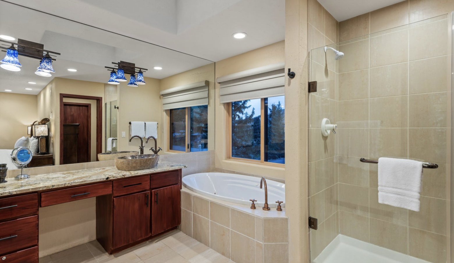 Spa-like bathroom with soaking tub, double vanity, and glass shower