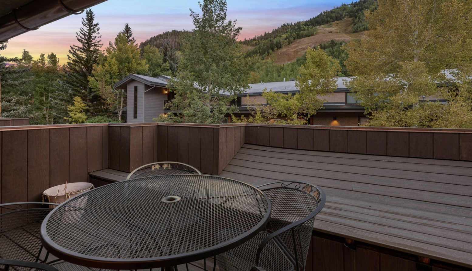 Private mountain-view deck with outdoor dining and peaceful tree-lined scenery