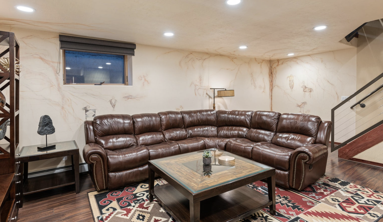 Spacious lounge with oversized leather sectional and stylish rustic touches