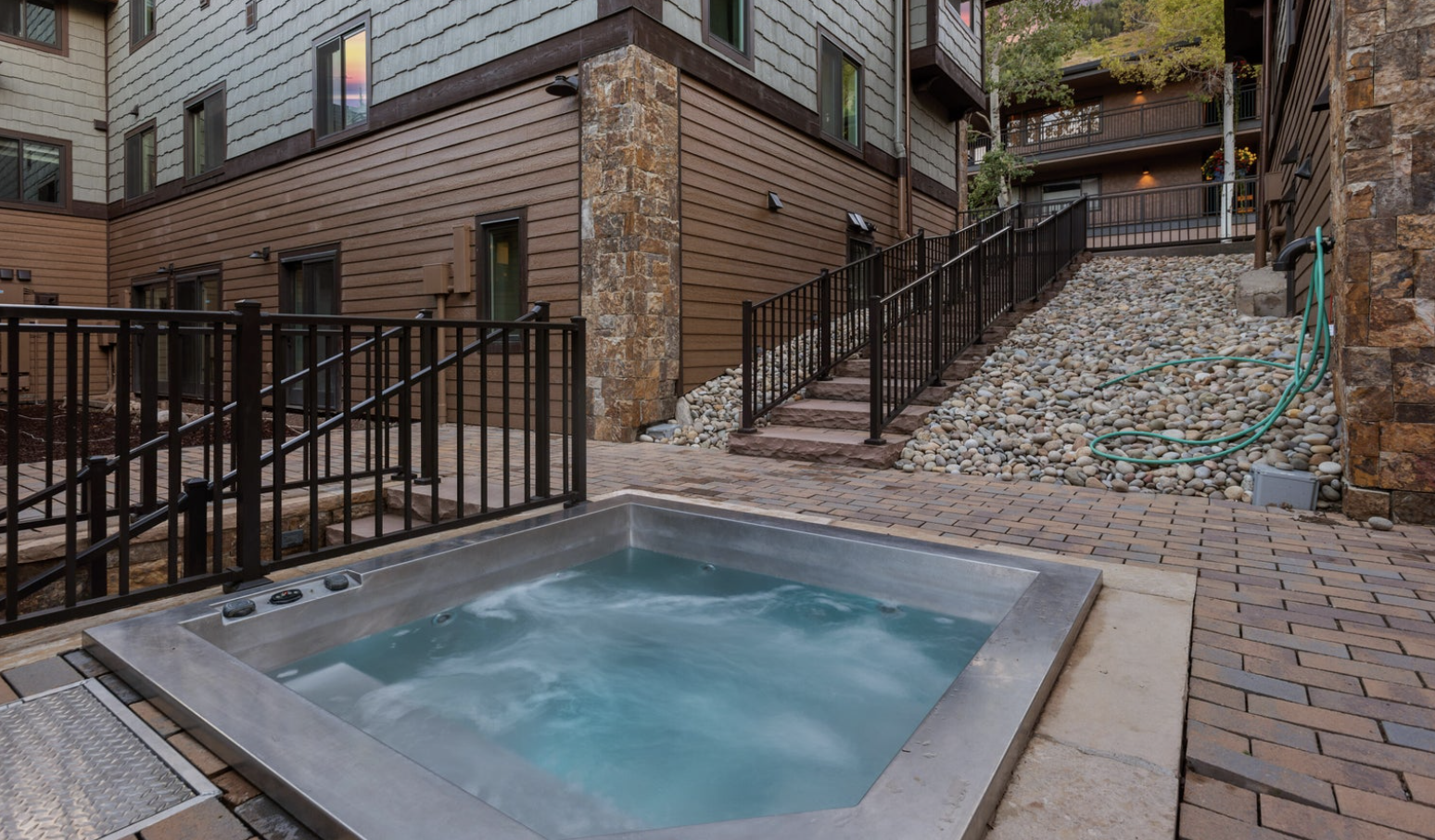 Private outdoor hot tub in a stylish mountain lodge setting