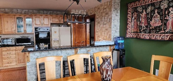 Rustic kitchen and dining area with breakfast bar and warm cabin charm