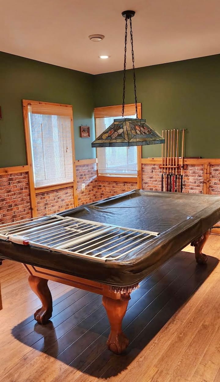 Inviting game room with full-size pool table and warm rustic charm