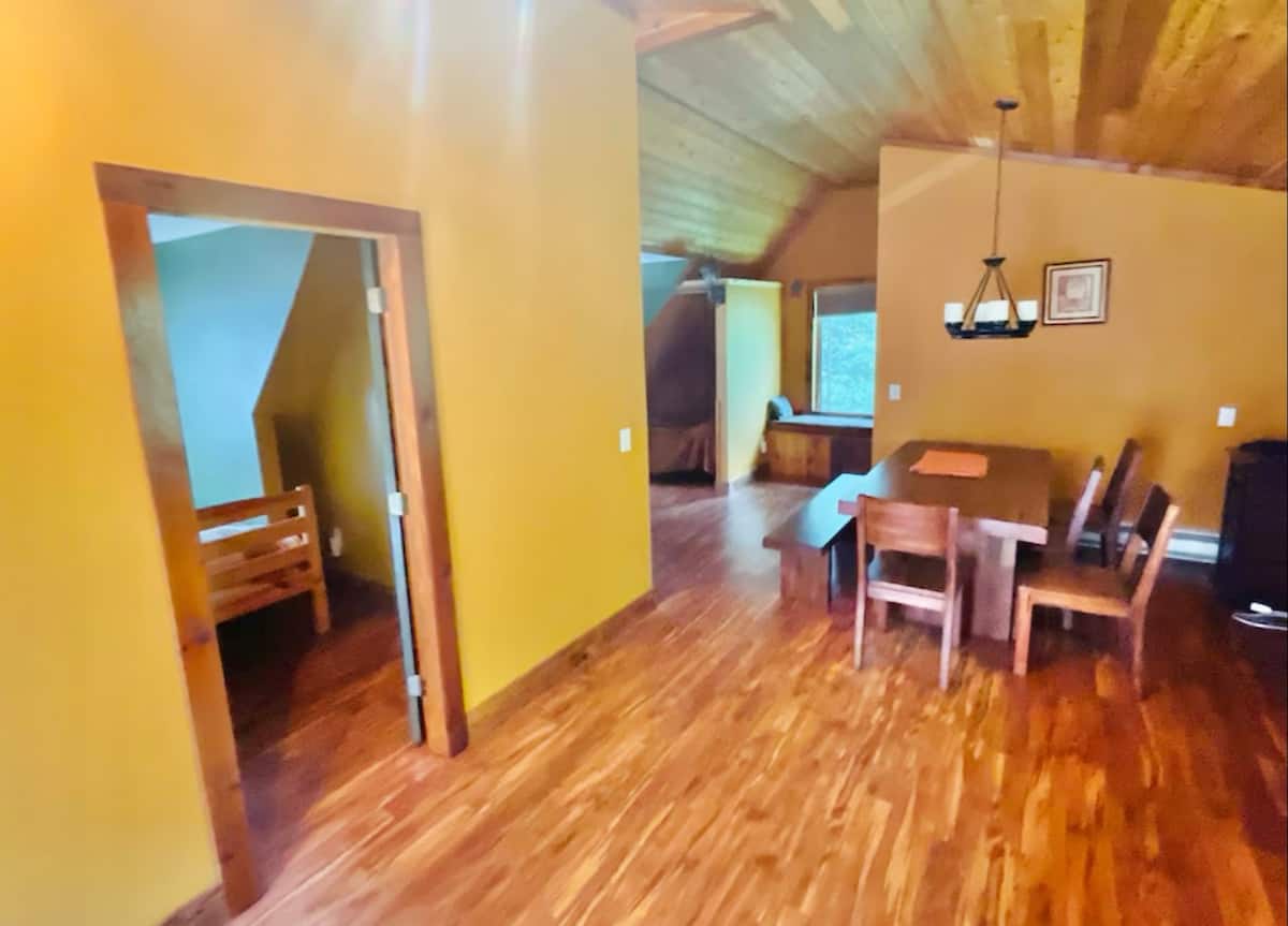 Rustic loft dining area with wood ceilings and cozy cabin charm