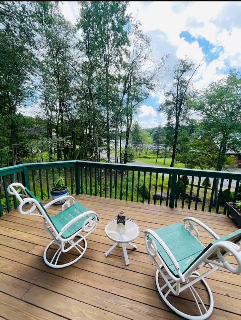 Peaceful wooded deck with rocking chairs and serene outdoor views