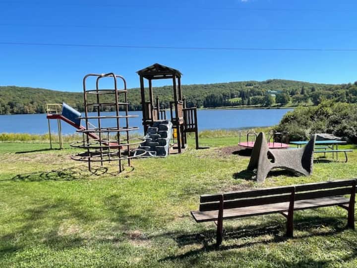 Family-friendly lakeside playground with scenic water and hill views