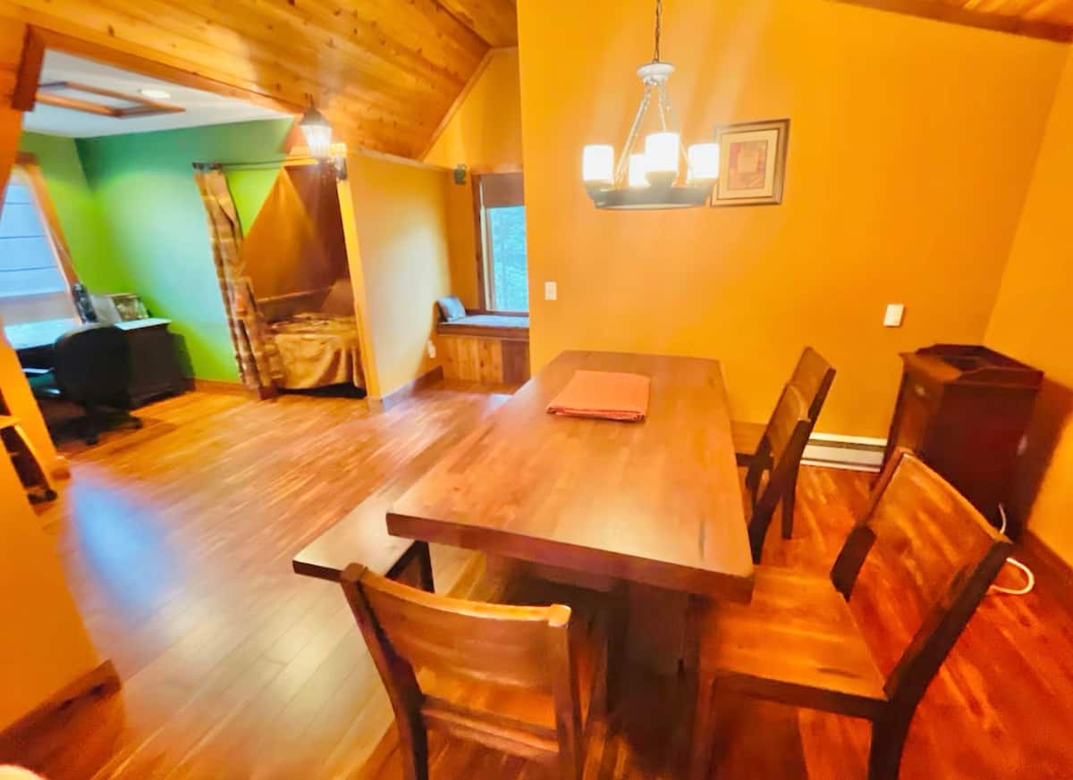 Warm wood dining space with vaulted ceilings and cozy open layout