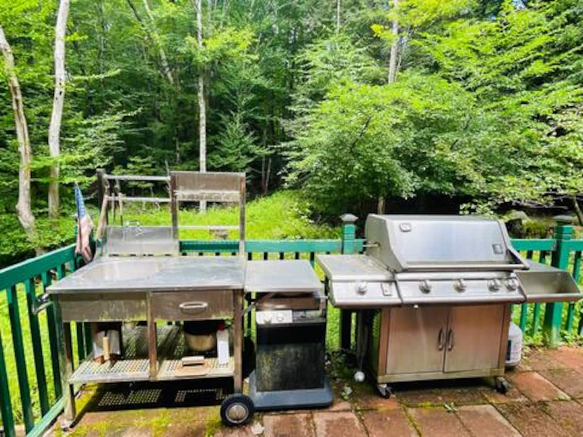 Private wooded deck with grill station for relaxed outdoor cookouts